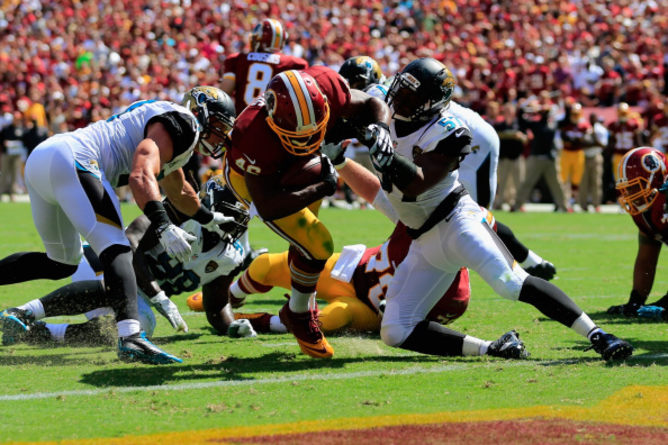 LANDOVER, MD - SEPTEMBER 14:  Running back Alfred Morris #46 of the Washington Redskins scores a touchdown past linebacker Dekoda Watson #57 of the Jacksonville Jaguars at FedExField on September 14, 2014 in Landover, Maryland.  (Photo by Rob Carr/Getty I