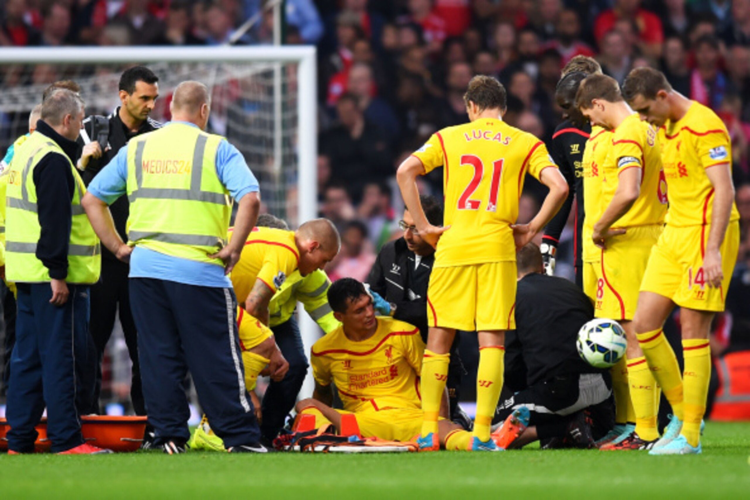 LONDON, ENGLAND - SEPTEMBER 20:  Dejan Lovren of Liverpool receives treatment following a clash of heads during the Barclays Premier League match between West Ham United and Liverpool at Boleyn Ground on September 20, 2014 in London, England.  (Photo by M