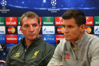 LIVERPOOL, ENGLAND - SEPTEMBER 15:  Liverpool manager Brendan Rodgers deep in thought whilst sitting next to his defender Dejan Lovren during a press conference ahead of their UEFA Champions League group B match against PFC Ludogorets on September 15, 201