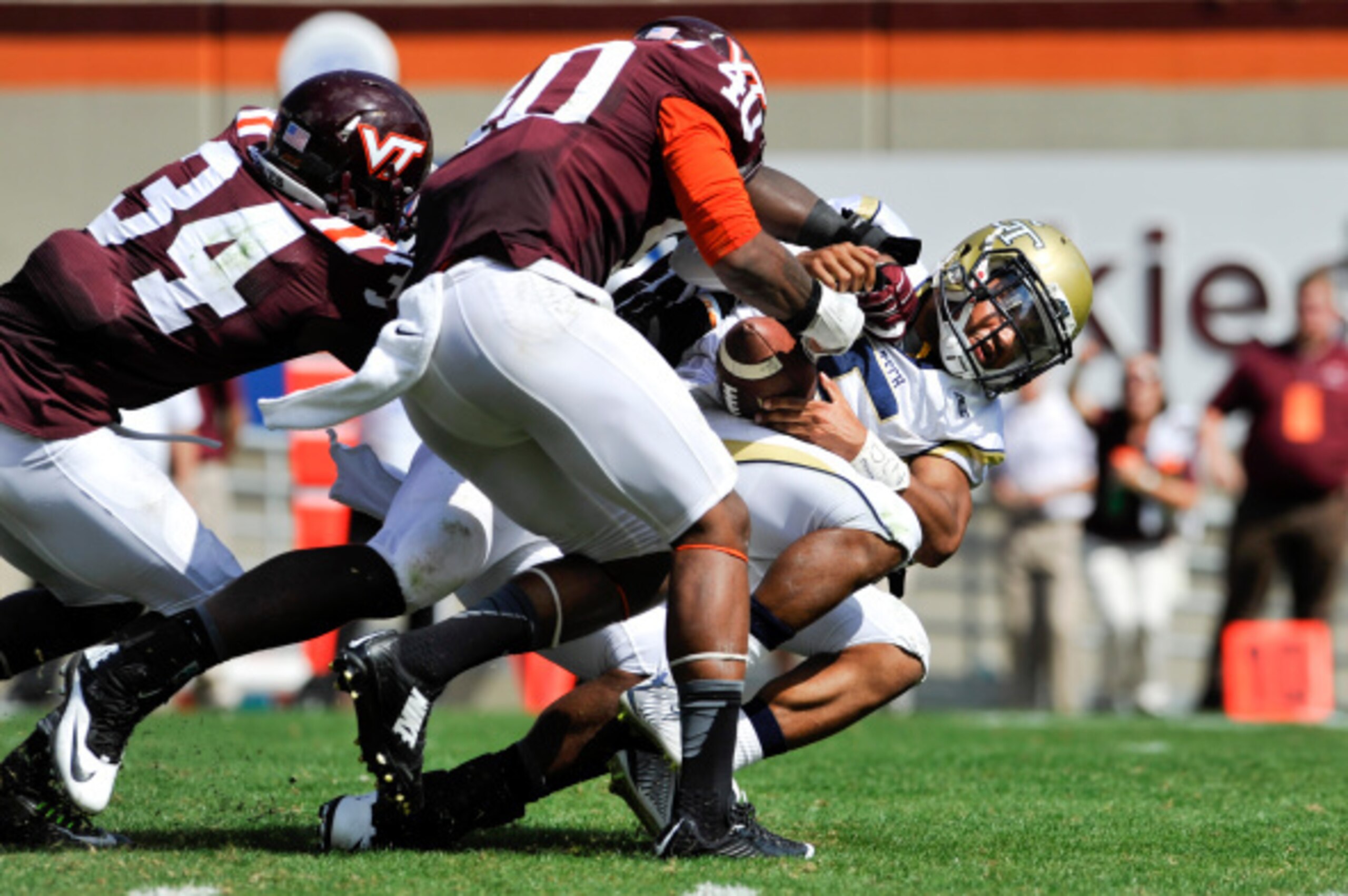 BLACKSBURG, VA - SEPTEMBER 20: Quarterback Justin Thomas #5 of the Georgia Tech Yellow Jackets fumbles after being hit by linebacker Deon Clarke #40 and rover Kyshoen Jarrett #34 of the Virginia Tech Hokies in the second half at Lane Stadium on September BLACKSBURG, VA - SEPTEMBER 20: Quarterback Justin Thomas #5 of the Georgia Tech Yellow Jackets fumbles after being hit by linebacker Deon Clarke #40 and rover Kyshoen Jarrett #34 of the Virginia Tech Hokies in the second half at Lane Stadium on September