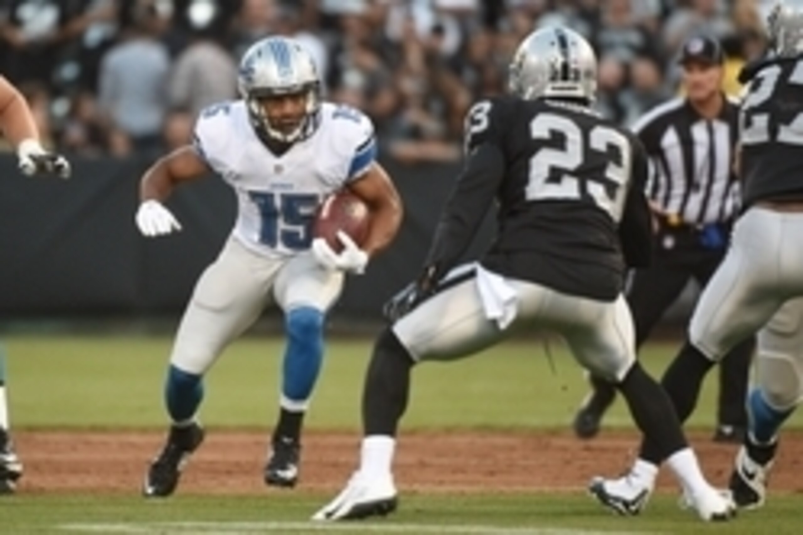 August 15, 2014; Oakland, CA, USA; Detroit Lions wide receiver Golden Tate (15) runs the football against Oakland Raiders cornerback Tarell Brown (23) during the first quarter at O.co Coliseum. The Raiders defeated the Lions 27-26. Mandatory Credit: Kyle 