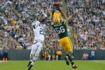 Sep 14, 2014; Green Bay, WI, USA; Green Bay Packers outside linebacker Julius Peppers (56) breaks up a pass intended for New York Jets running back Chris Johnson (21) during the second half of a game at Lambeau Field. Green Bay won 31-24. Mandatory Credit