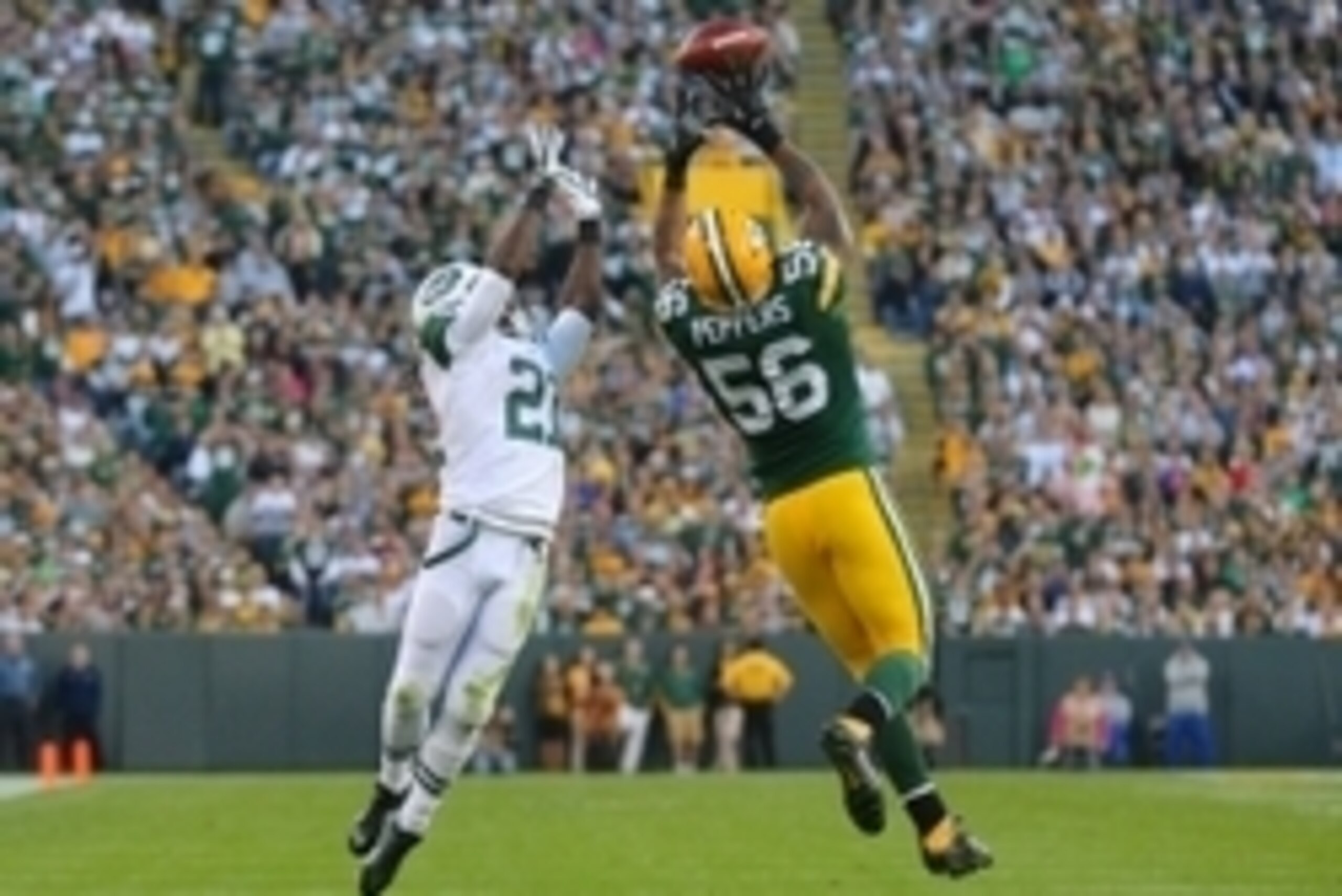 Sep 14, 2014; Green Bay, WI, USA; Green Bay Packers outside linebacker Julius Peppers (56) breaks up a pass intended for New York Jets running back Chris Johnson (21) during the second half of a game at Lambeau Field. Green Bay won 31-24. Mandatory Credit