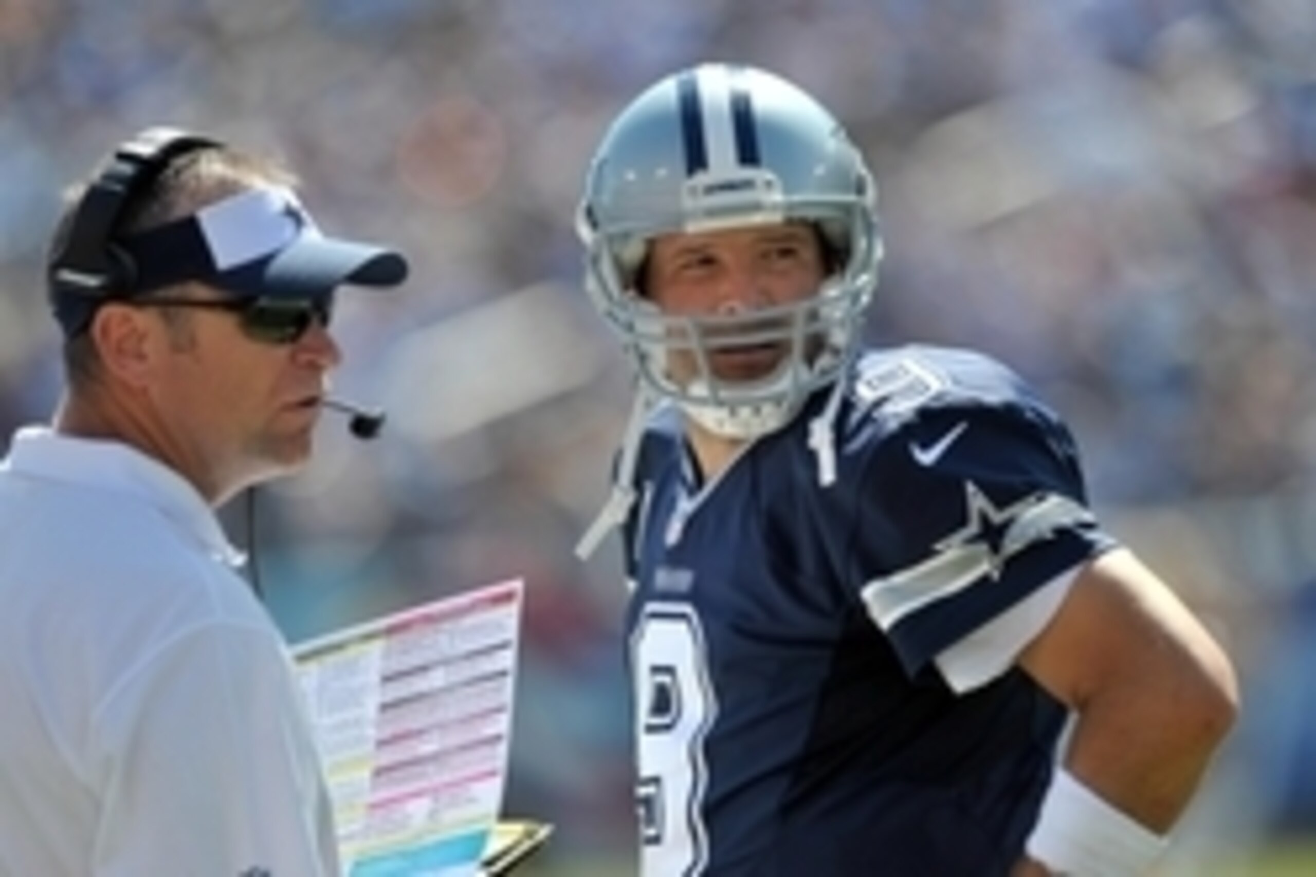 Sep 14, 2014; Nashville, TN, USA; Dallas Cowboys passing game coordinator Scott Linehan talks with Dallas quarterback Tony Romo (9) on the sideline during the second half Tennessee Titans at LP Field. Dallas won 26-10. Mandatory Credit: Jim Brown-USA TODA