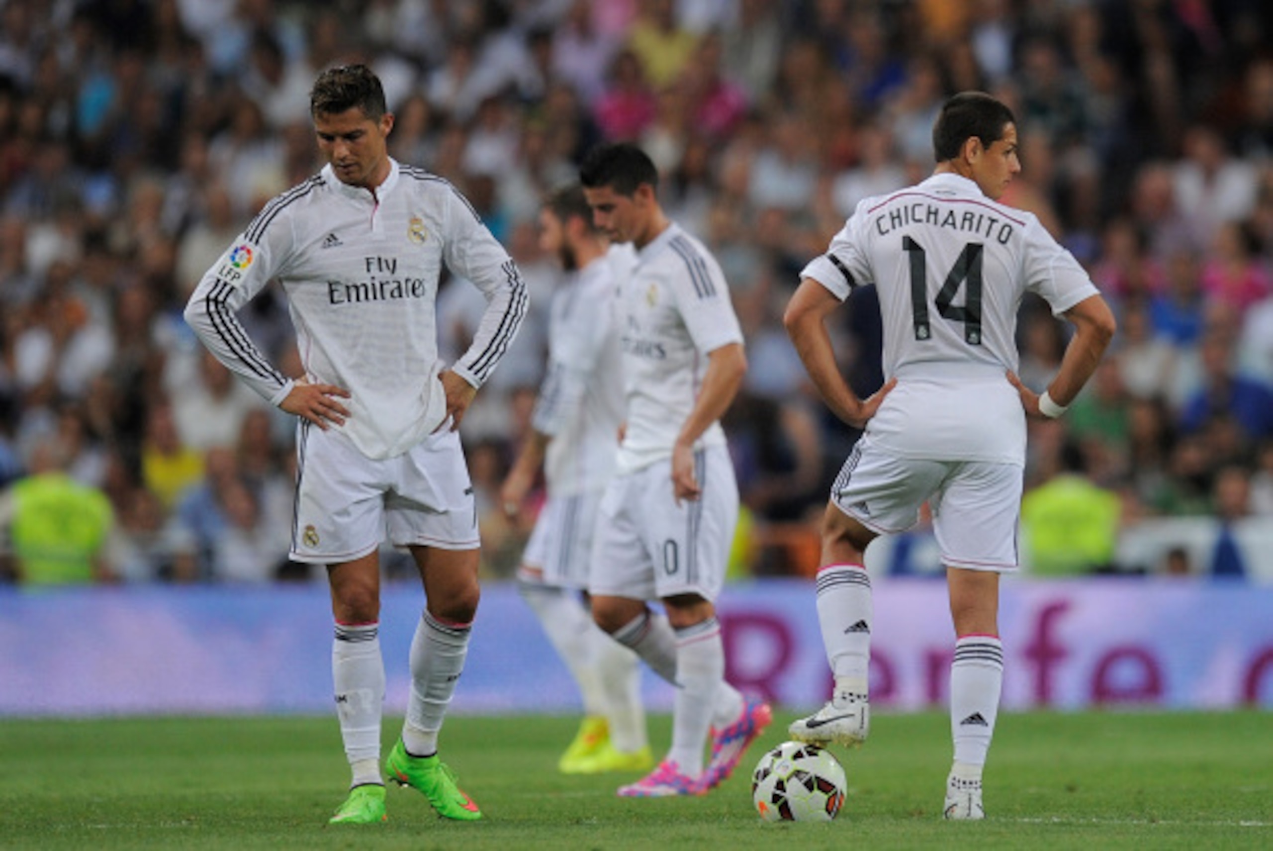 MADRID, SPAIN - SEPTEMBER 13:  Cristiano Ronaldo of Real Madrid reacts beside  Javier 'Chicharito' Hernandez  after Atletico de Madrid scored their 2nd goal during the La Liga match between Real Madrid and Atletico de Madrid at Estadio Santiago Bernabeu o