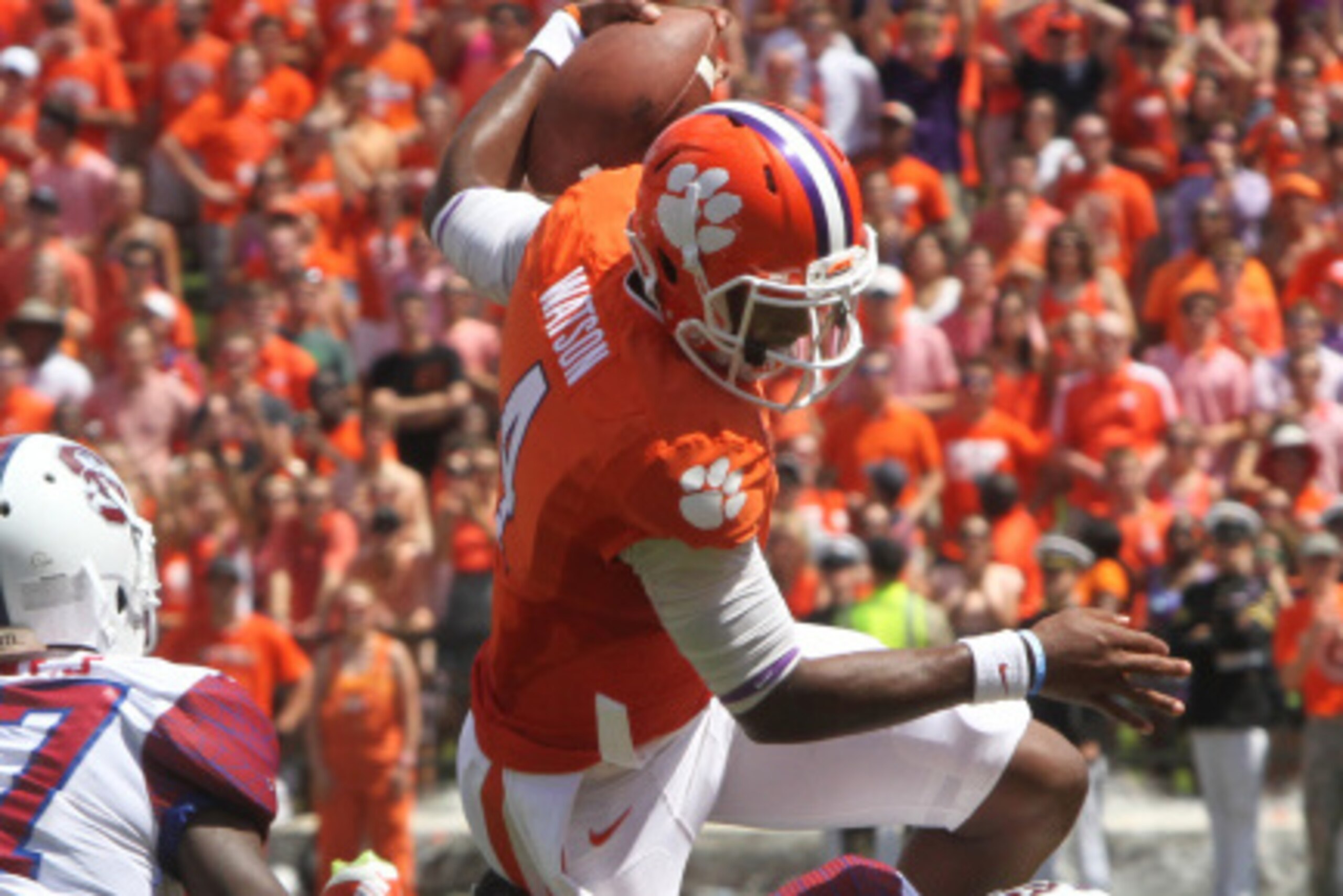 CLEMSON, SC - SEPTEMBER 6: Quarterback Deshaun Watson #4 of the Clemson Tigers hurtles over free safety Mariel Cooper #20 of the South Carolina State Bulldogs on September 6, 2014 at Memorial Stadium in Clemson, South Carolina. (Photo by Mary Ann Chasta CLEMSON, SC - SEPTEMBER 6: Quarterback Deshaun Watson #4 of the Clemson Tigers hurtles over free safety Mariel Cooper #20 of the South Carolina State Bulldogs on September 6, 2014 at Memorial Stadium in Clemson, South Carolina. (Photo by Mary Ann Chasta