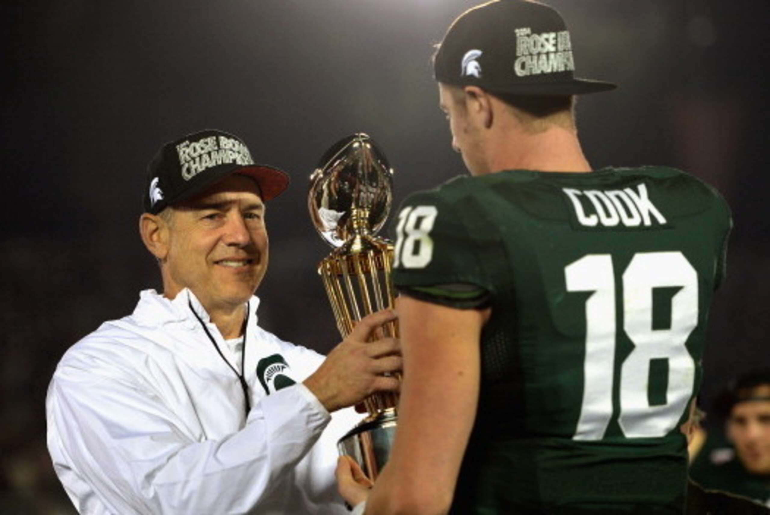 PASADENA, CA - JANUARY 01:  Michigan State Spartans head coach Mark Dantonio and quarterback Connor Cook #18 celebrate with the Rose Bowl Game trophy after defeating the Stanford Cardinal 24-20 in the 100th Rose Bowl Game presented by Vizio at the Rose Bo