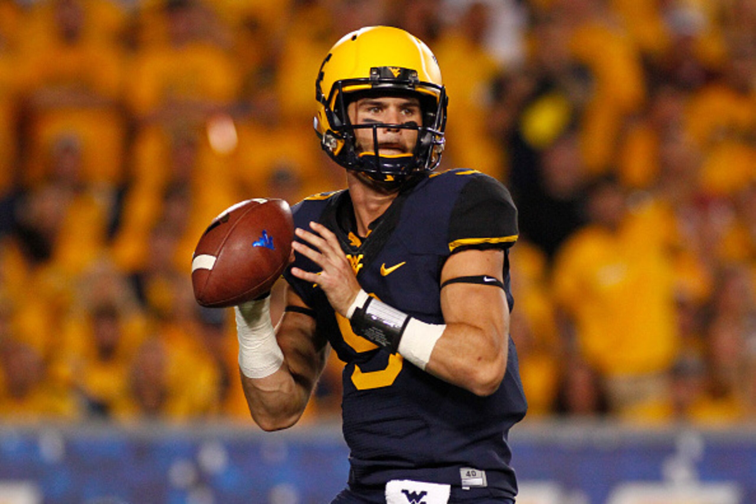 MORGANTOWN, WV - SEPTEMBER 20:  Clint Trickett #9 of the West Virginia Mountaineers drops back to pass in the first half during the game against the Oklahoma Sooners on September 20, 2014 at Mountaineer Field in Morgantown, West Virginia.  (Photo by Justi
