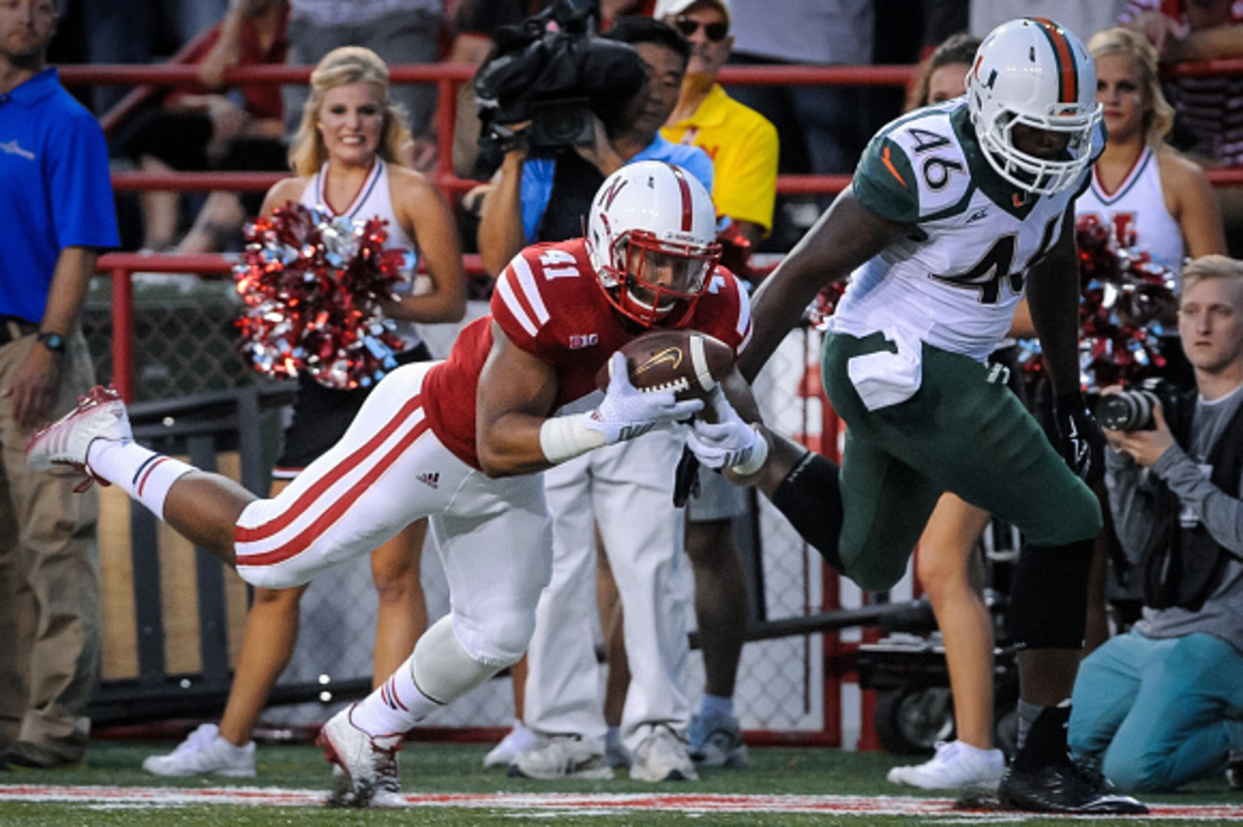 LINCOLN, NE - SEPTEMPER 20: Defensive back Creighton Koley #42 of the Nebraska Cornhuskers intercepts a ball intended for tight end Clive Walford #46 of the Miami Hurricanes during their game at Memorial Stadium on September 20, 2014 in Lincoln, Nebraska.