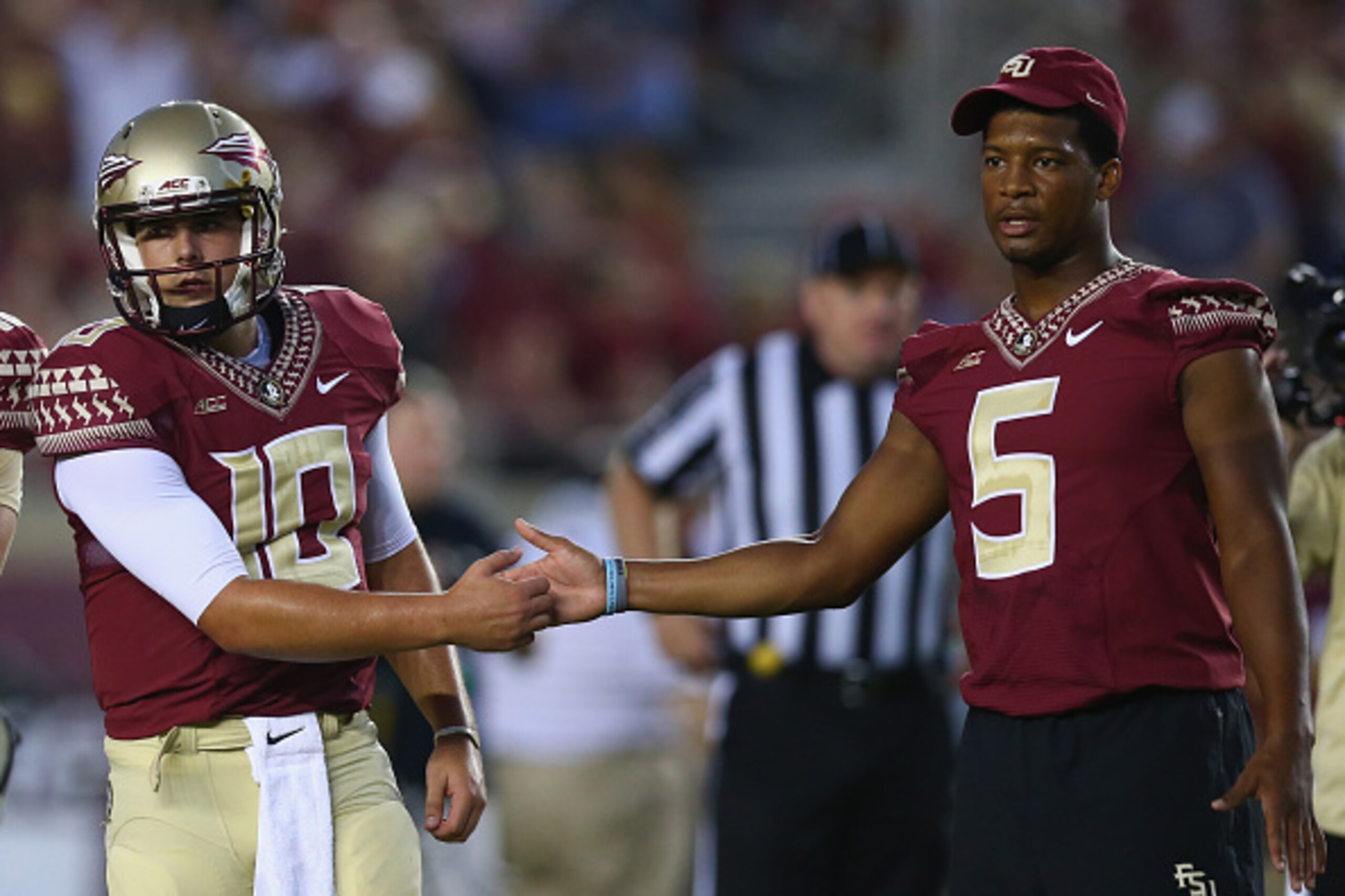 TALLAHASSEE, FL - SEPTEMBER 20:  Jameis Winston #5 of the Florida State Seminoles shakes hands with Sean Maguire #10 on the field during pregame against the Clemson Tigers at Doak Campbell Stadium on September 20, 2014 in Tallahassee, Florida.  (Photo by 