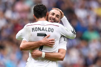 LA CORUNA, SPAIN - SEPTEMBER 20:  Cristiano Ronaldo of Real Madrid CF celebrates with his teammate Karim Benzema of Real Madrid CF after scoring his team's third goalduring the La Liga match between RC Deportivo La Coruna and Real Madrid CF at Riazor Stad