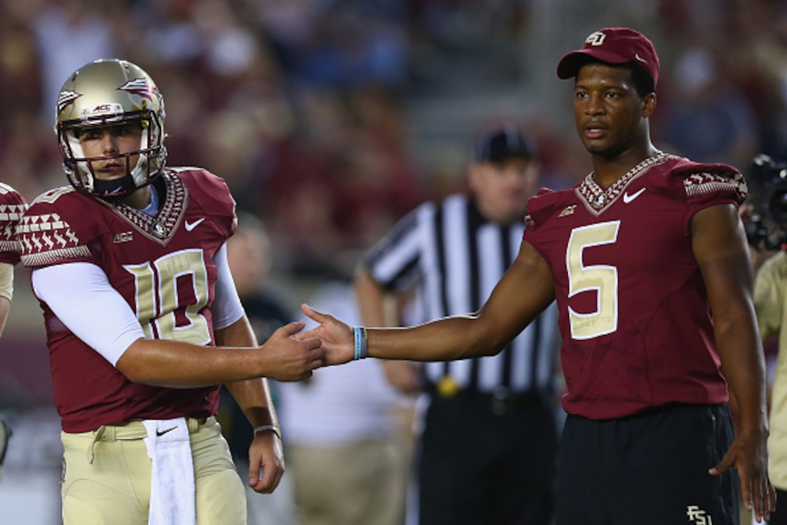 TALLAHASSEE, FL - SEPTEMBER 20: Jameis Winston #5 of the Florida State Seminoles shakes hands with Sean Maguire #10 on the field during pregame against the Clemson Tigers at Doak Campbell Stadium on September 20, 2014 in Tallahassee, Florida. (Photo by TALLAHASSEE, FL - SEPTEMBER 20: Jameis Winston #5 of the Florida State Seminoles shakes hands with Sean Maguire #10 on the field during pregame against the Clemson Tigers at Doak Campbell Stadium on September 20, 2014 in Tallahassee, Florida. (Photo by