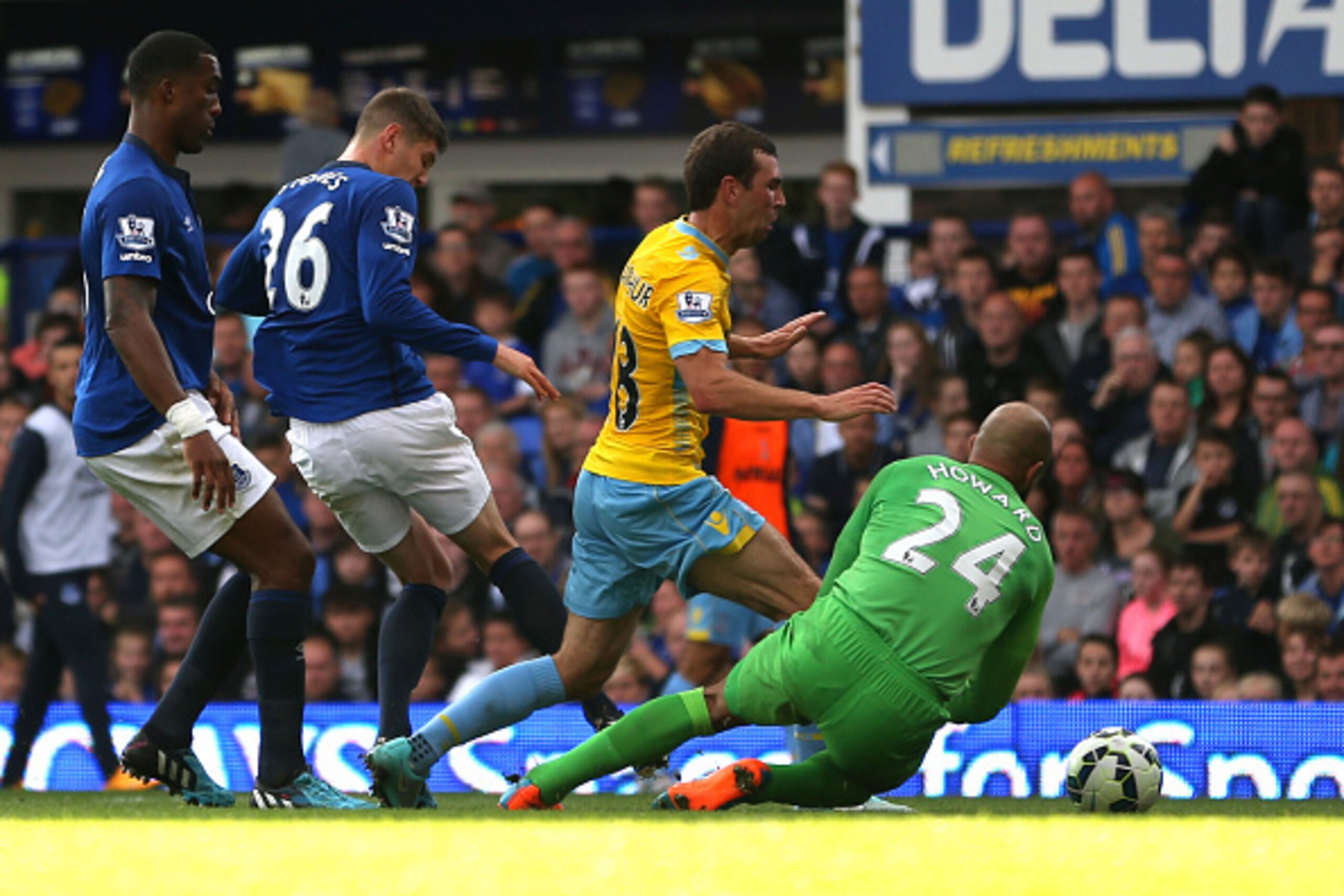 LIVERPOOL, ENGLAND - SEPTEMBER 21:  Tim Howard of Everton concedes a penalty as he brings down James McArthur of Crystal Palace during the Barclays Premier League match between Everton and Crystal Palace at Goodison Park on September 21, 2014 in Liverpool