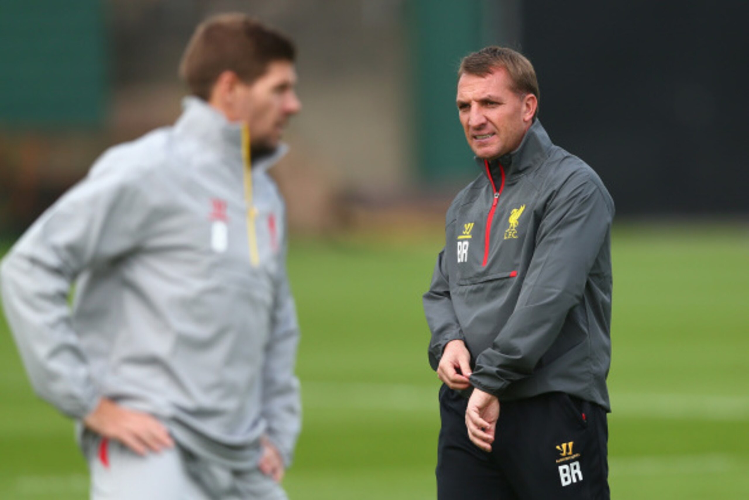 LIVERPOOL, ENGLAND - SEPTEMBER 15:  Liverpool manager Brendan Rodgers about to check his watch as he walks past Liverpool captain Steven Gerrard during a training session ahead of their UEFA Champions League group B match against PFC Ludogorets on Septemb