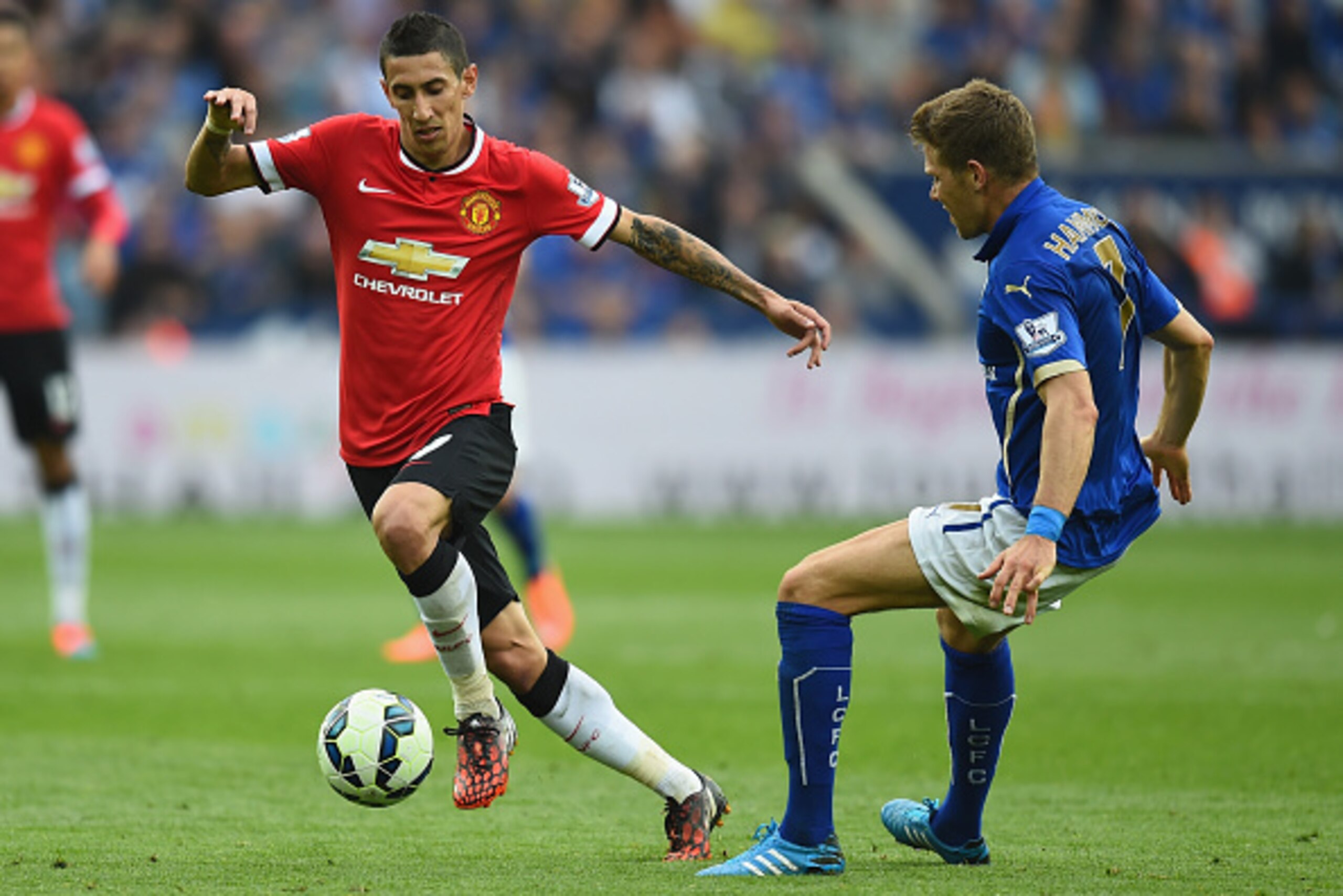 LEICESTER, ENGLAND - SEPTEMBER 21:  Angel Di Maria of Manchester United gets past Dean Hammond of Leicester during the Barclays Premier League match between Leicester City and Manchester United at The King Power Stadium on September 21, 2014 in Leicester,