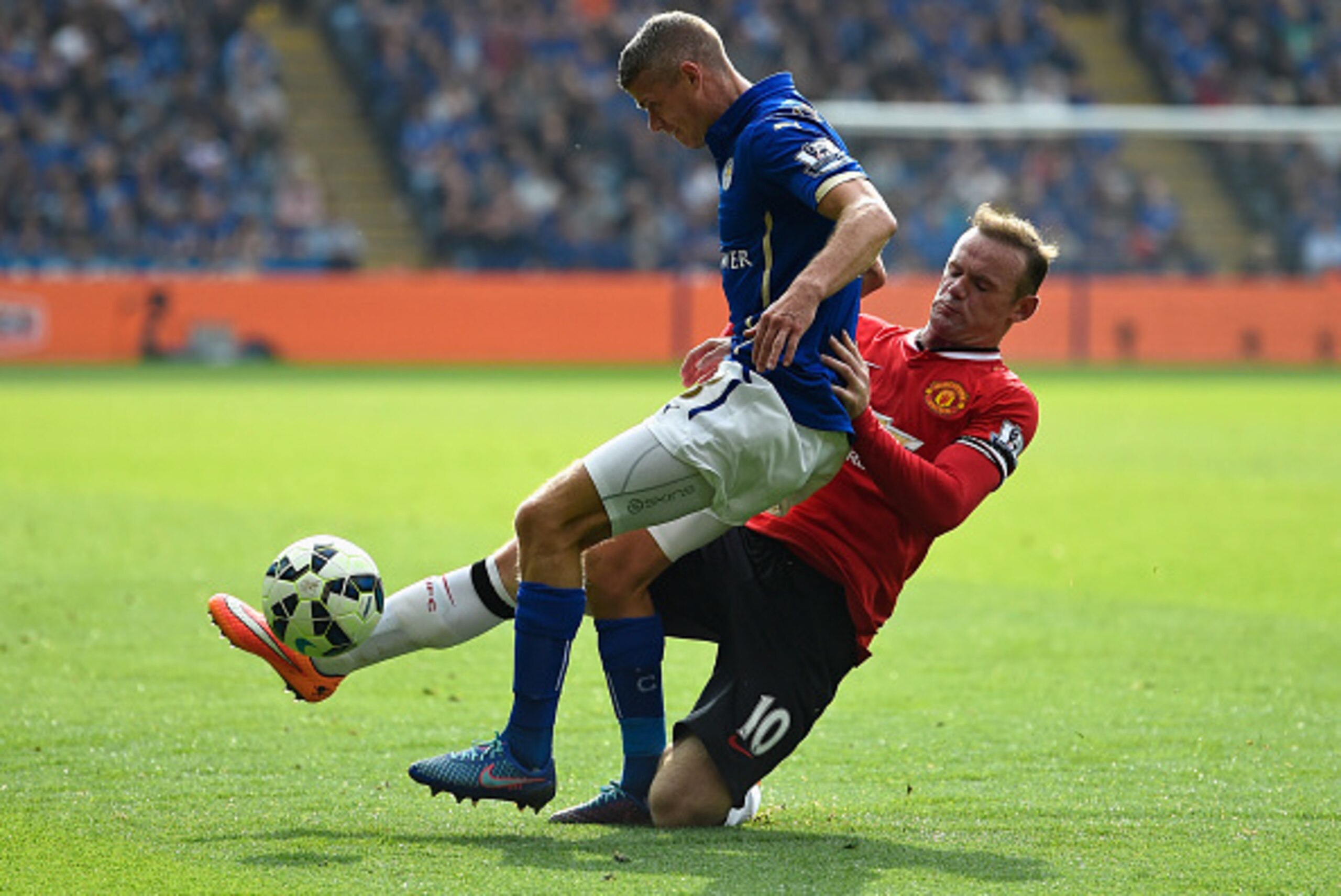 LEICESTER, ENGLAND - SEPTEMBER 21:  Paul Konchesky of Leicester is challenged by Wayne Rooney of Manchester United during the Barclays Premier League match between Leicester City and Manchester United at The King Power Stadium on September 21, 2014 in Lei