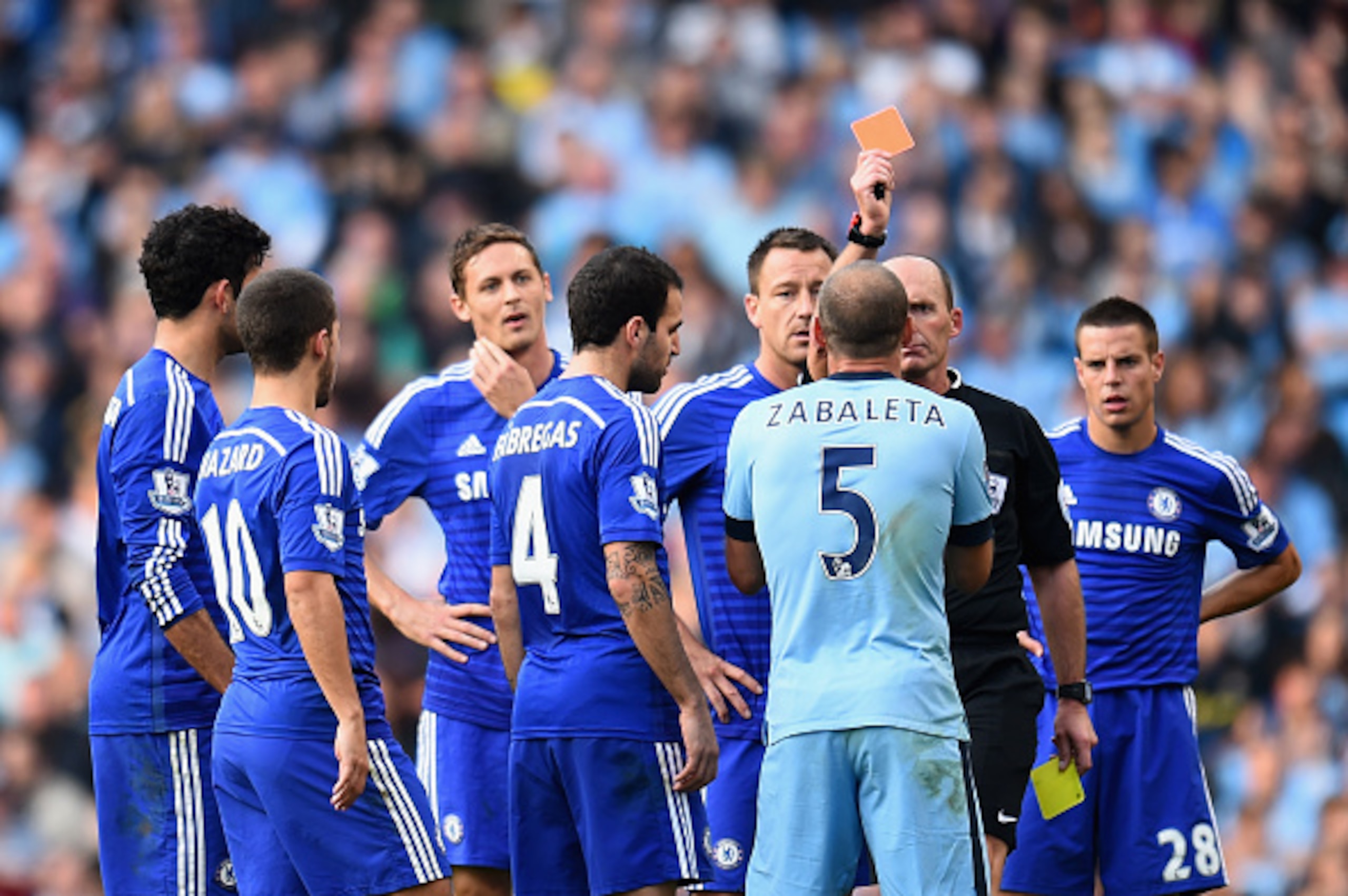 MANCHESTER, ENGLAND - SEPTEMBER 21:  Referee Mike Dean shows a red card to Pablo Zabaleta of Manchester City during the Barclays Premier League match between Manchester City and Chelsea at the Etihad Stadium on September 21, 2014 in Manchester, England.  