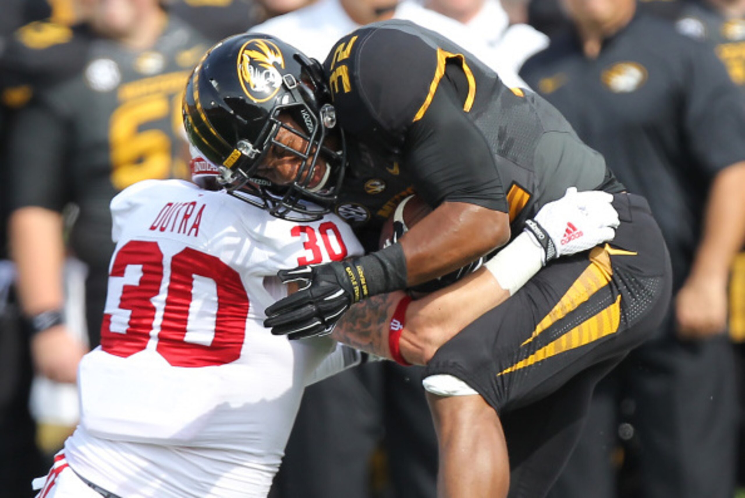 COLUMBIA , MO - SEPTEMBER 20:  Running back Russell Hansbrough #32 of the Missouri Tigers is tackled by safety Chase Dutra #30 of the Indiana Hoosiers in the first quarter at Memorial Stadium on September 20, 2014 in Columbia, Missouri.  (Photo by Ed Zurg