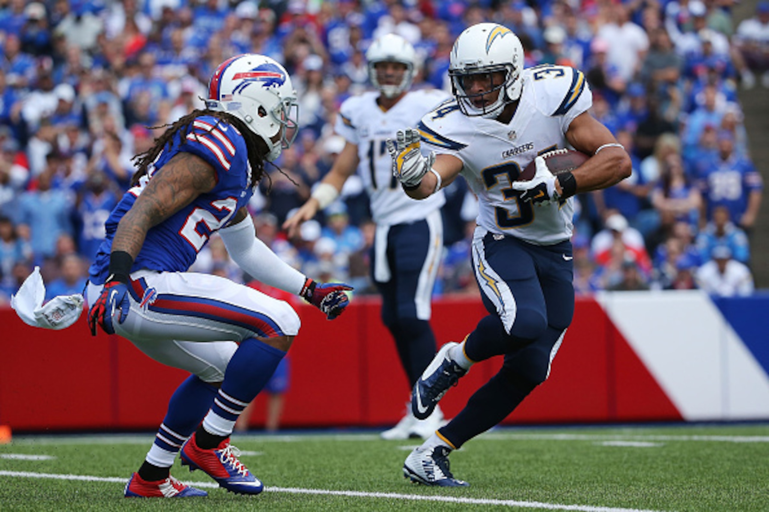 ORCHARD PARK, NY - SEPTEMBER 21:  Donald Brown #34 of the San Diego Chargers runs the ball as Stephon Gilmore #24 of the Buffalo Bills defends during the first half at Ralph Wilson Stadium on September 21, 2014 in Orchard Park, New York.  (Photo by Tom Sz