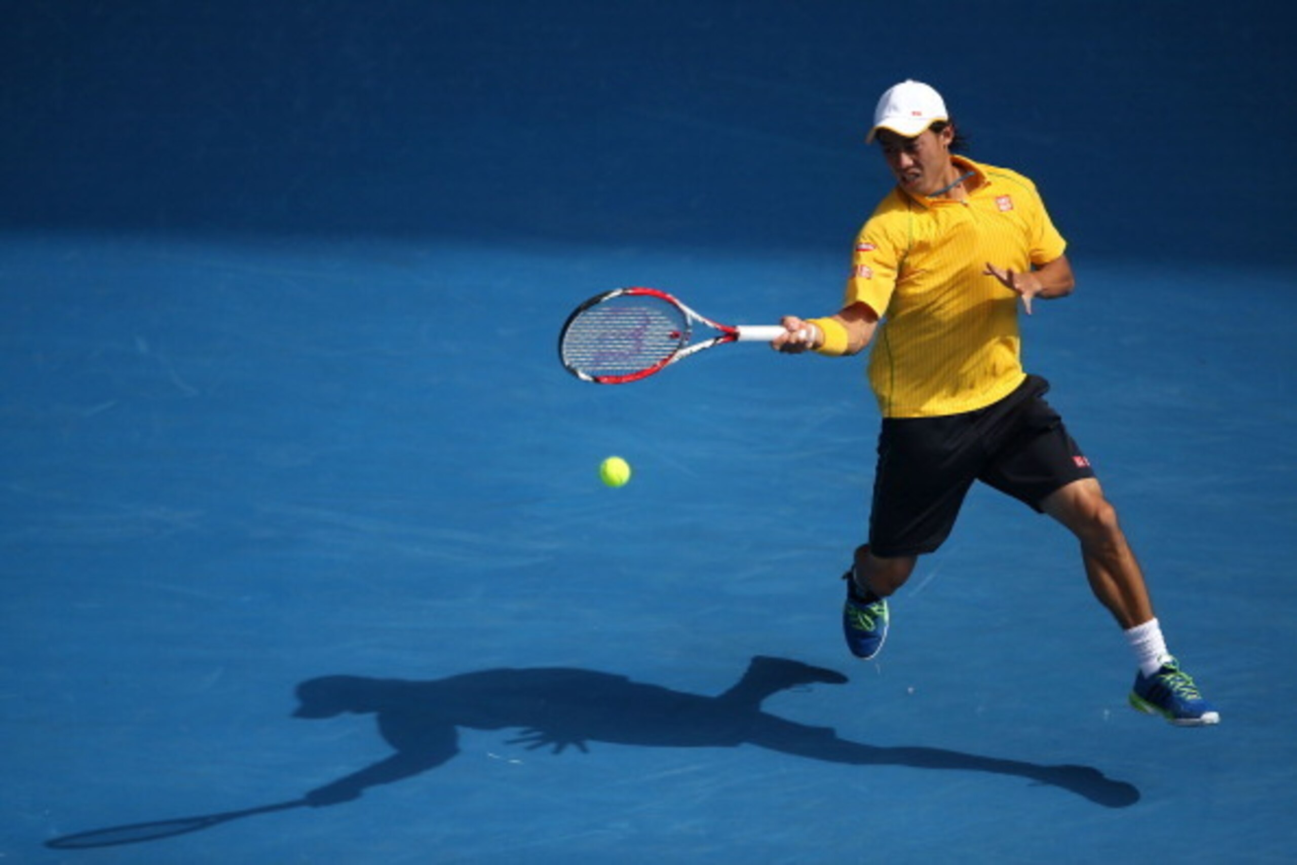 MELBOURNE, AUSTRALIA - JANUARY 20:  Kei Nishikori of Japan plays a forehand in his fourth round match against Rafael Nadal of Spain during day eight of the 2014 Australian Open at Melbourne Park on January 20, 2014 in Melbourne, Australia.  (Photo by Cliv