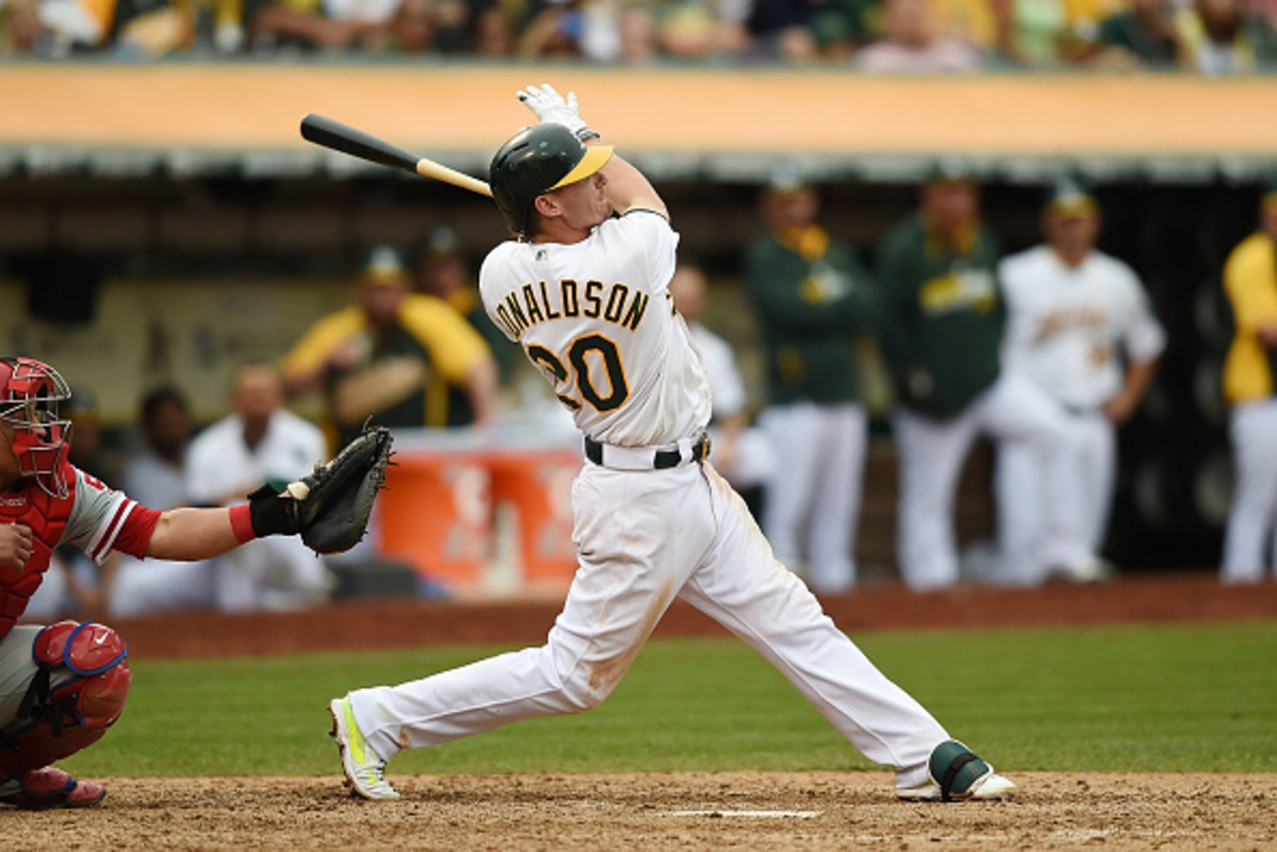 OAKLAND, CA - SEPTEMBER 21:  Josh Donaldson #20 of the Oakland Athletics hits a walk-off, two-run homer against the Philadelphia Phillies in the bottom of the tenth inning at O.co Coliseum on September 21, 2014 in Oakland, California. The Athletics won th