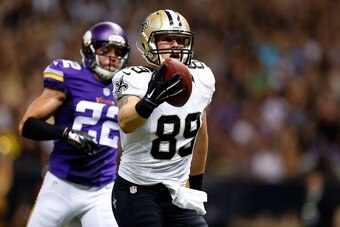 NEW ORLEANS, LA - SEPTEMBER 21:  Josh Hill #89 of the New Orleans Saints scores a touchdown in front of Harrison Smith #22 of the Minnesota Vikings during the first quarter of a game at the Mercedes-Benz Superdome on September 21, 2014 in New Orleans, Lou