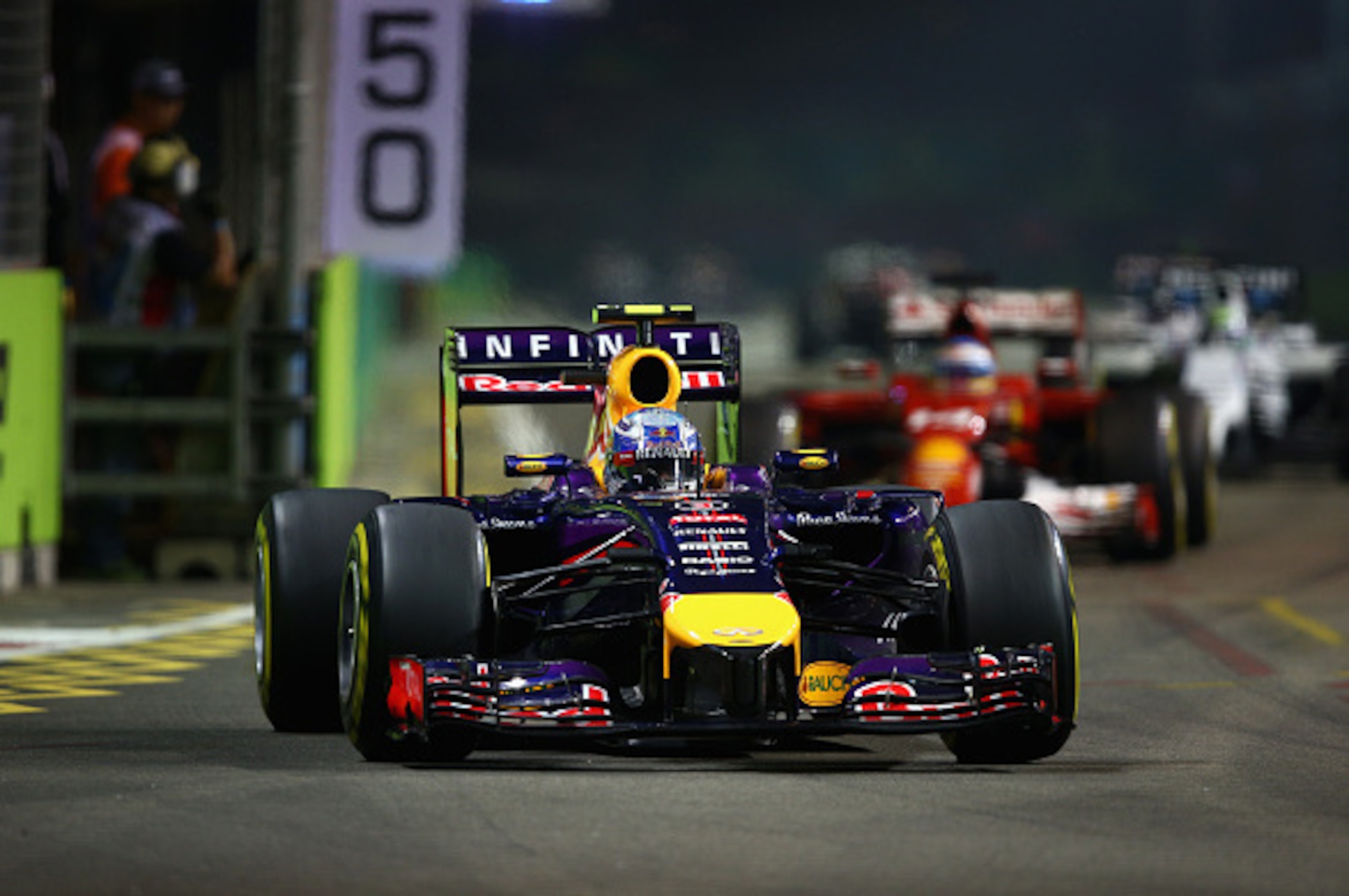 SINGAPORE - SEPTEMBER 21:  Daniel Ricciardo of Australia and Infiniti Red Bull Racing leads Fernando Alonso of Spain and Ferrari during the Singapore Formula One Grand Prix at Marina Bay Street Circuit on September 21, 2014 in Singapore, Singapore.  (Phot
