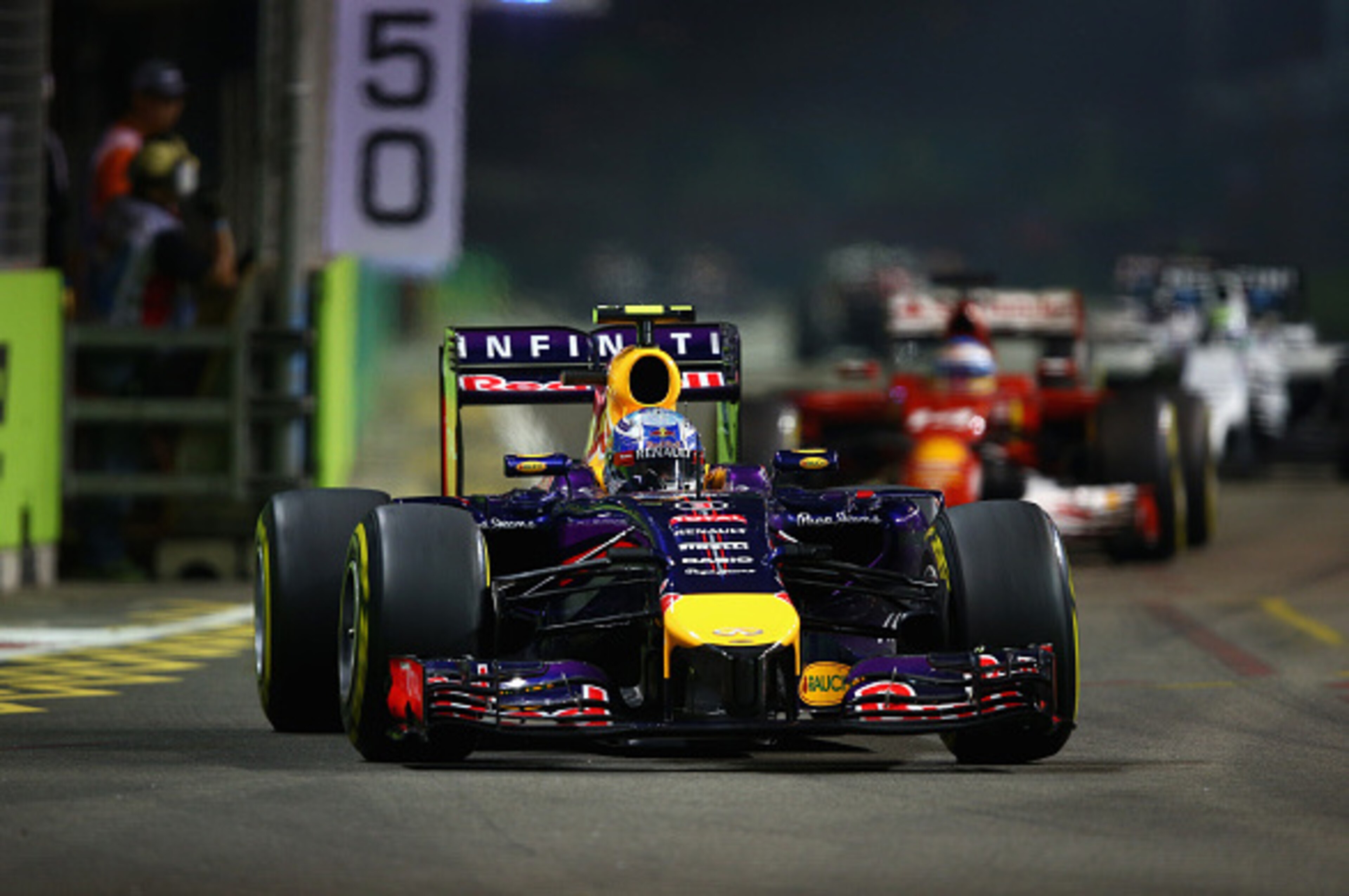 SINGAPORE - SEPTEMBER 21:  Daniel Ricciardo of Australia and Infiniti Red Bull Racing leads Fernando Alonso of Spain and Ferrari during the Singapore Formula One Grand Prix at Marina Bay Street Circuit on September 21, 2014 in Singapore, Singapore.  (Phot