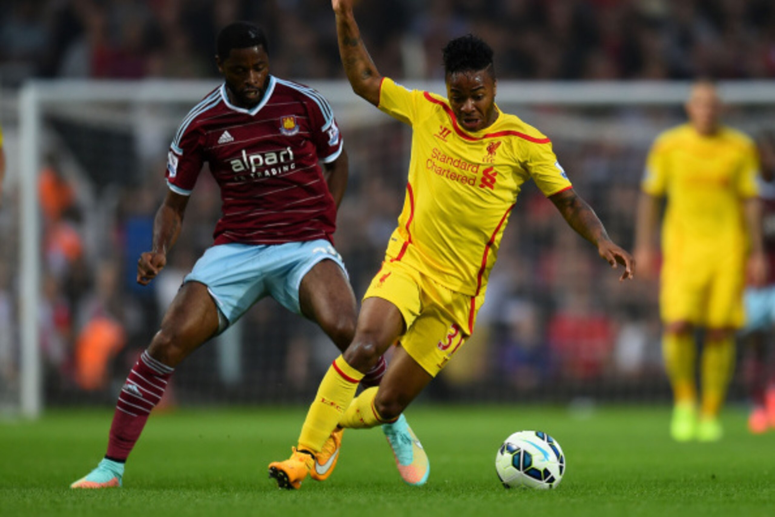LONDON, ENGLAND - SEPTEMBER 20:  Raheem Sterling of Liverpool is challenged by Alexandre Song of West Ham during the Barclays Premier League match between West Ham United and Liverpool at Boleyn Ground on September 20, 2014 in London, England.  (Photo by 