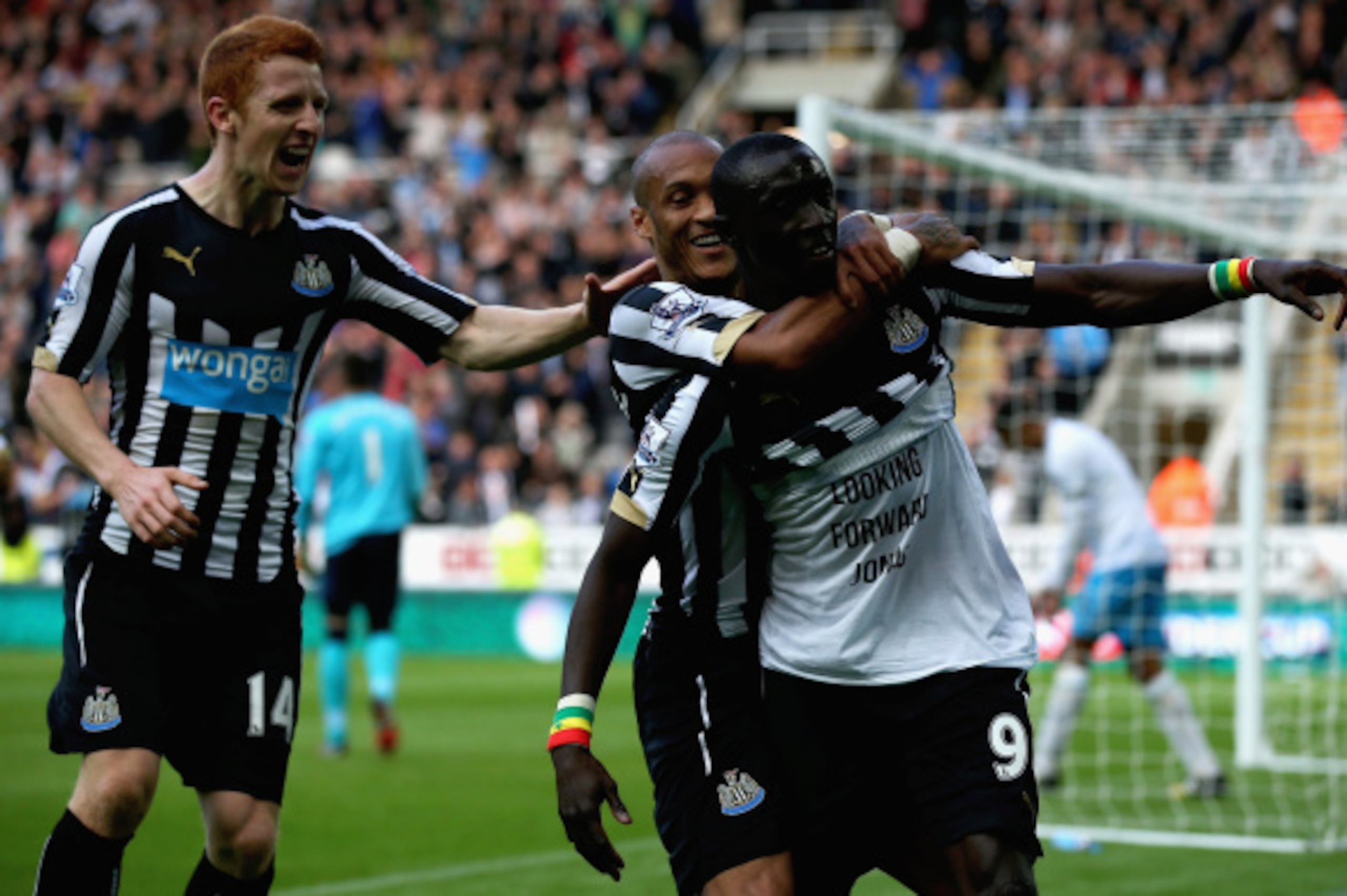 NEWCASTLE UPON TYNE, ENGLAND - SEPTEMBER 20:   Papiss Cisse of Newcastle United is congratulated on his second goal during the Barclays Premier League match between Newcastle United and Hull City at St James' Park on September 20, 2014 in Newcastle upon T