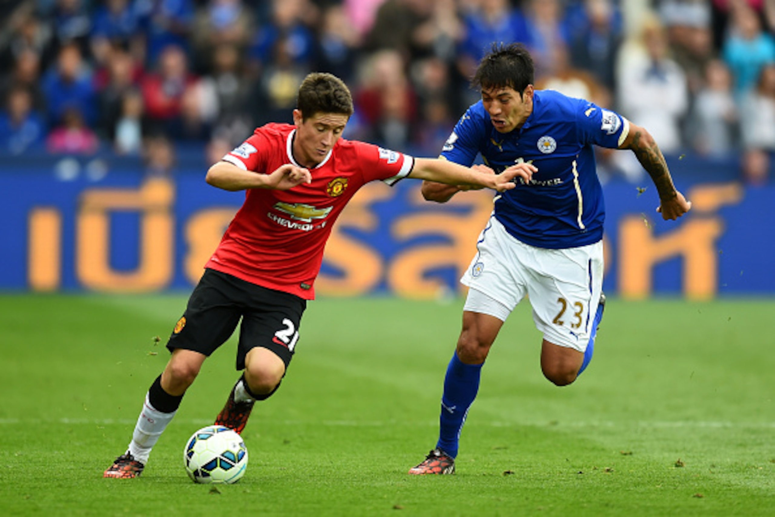 LEICESTER, ENGLAND - SEPTEMBER 21:  Ander Herrera of Manchester United challenged by Leonardo Ulloa of Leicester City during the Barclays Premier League match between Leicester City and Manchester United at The King Power Stadium on September 21, 2014 in 