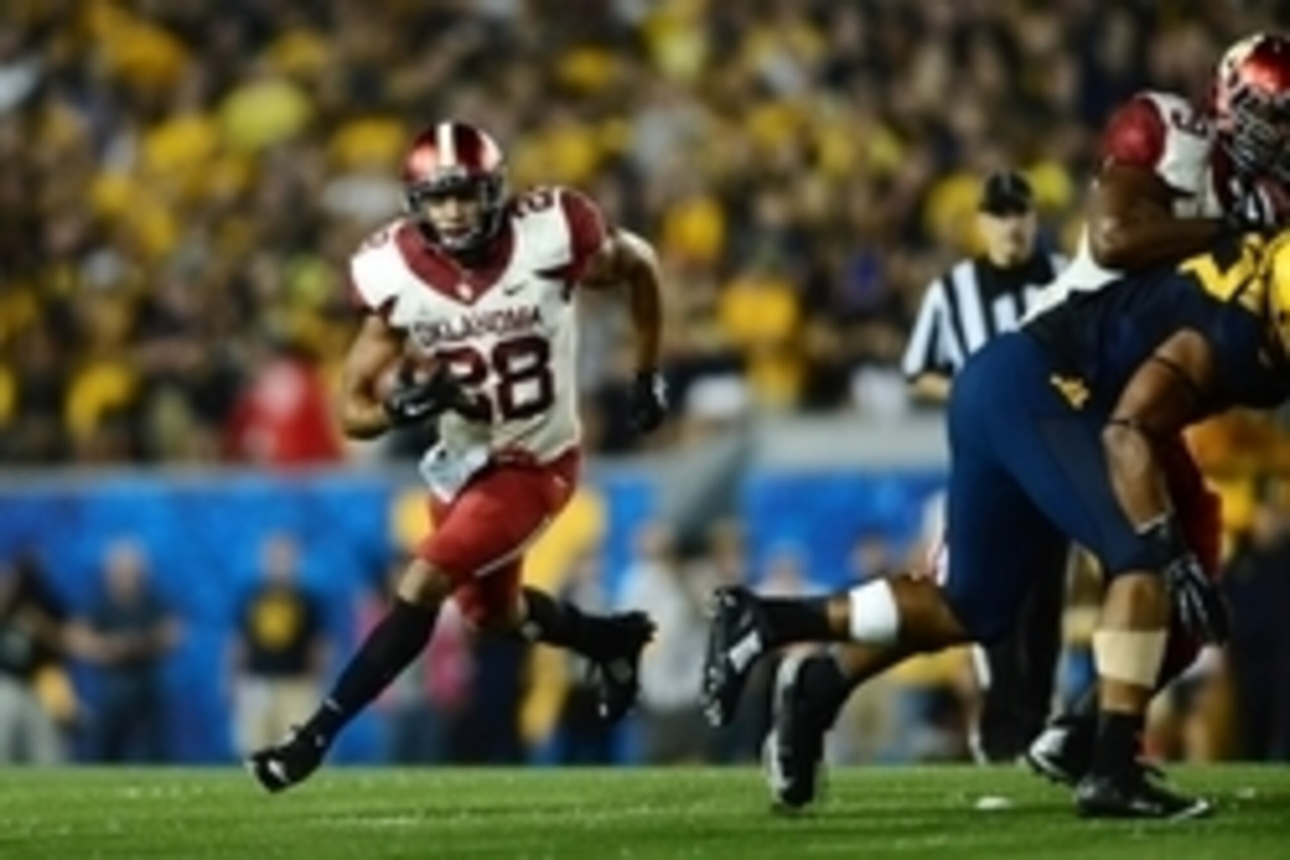 Sep 20, 2014; Morgantown, WV, USA; Oklahoma Sooners running back Alex Ross (28) runs the ball during the third quarter against the West Virginia Mountaineers at Milan Puskar Stadium. Mandatory Credit: Andrew Weber-USA TODAY Sports