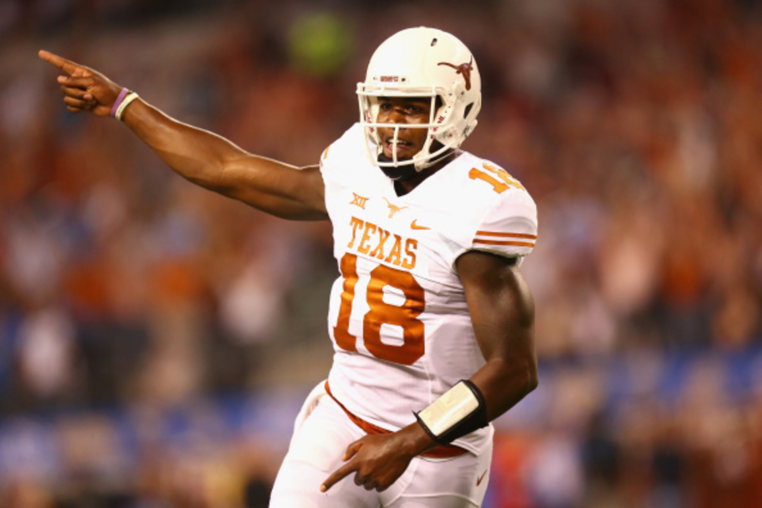 ARLINGTON, TX - SEPTEMBER 13:  Tyrone Swoopes #18 of the Texas Longhorns celebrates his touchdown pass against the UCLA Bruins in the second quarter at AT&T Stadium on September 13, 2014 in Arlington, Texas.  (Photo by Ronald Martinez/Getty Images)