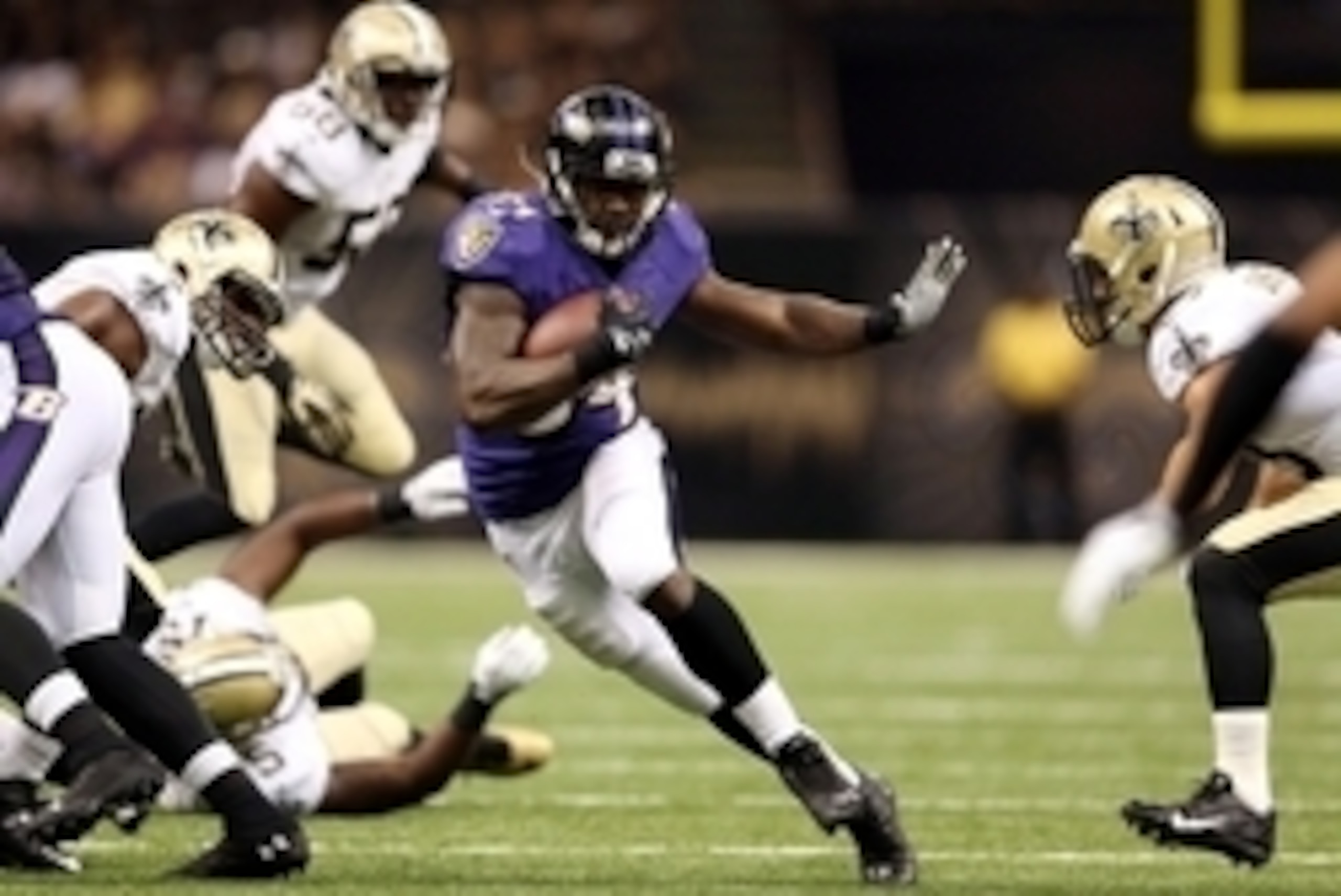 Aug 28, 2014; New Orleans, LA, USA; Baltimore Ravens running back Lorenzo Taliaferro (34) runs through a hole in the New Orleans Saints defense in the second quarter of their game at the Mercedes-Benz Superdome. Mandatory Credit: Chuck Cook-USA TODAY Spor