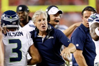 KANSAS CITY, MO - AUGUST 24:  Head coach Pete Caroll of the Seattle Seahawks congratulates quarterback  Russell Wilson #3 after a touchdown during the NFL preseason game against the Kansas City Chiefs at Arrowhead Stadium on August 24, 2012 in Kansas City