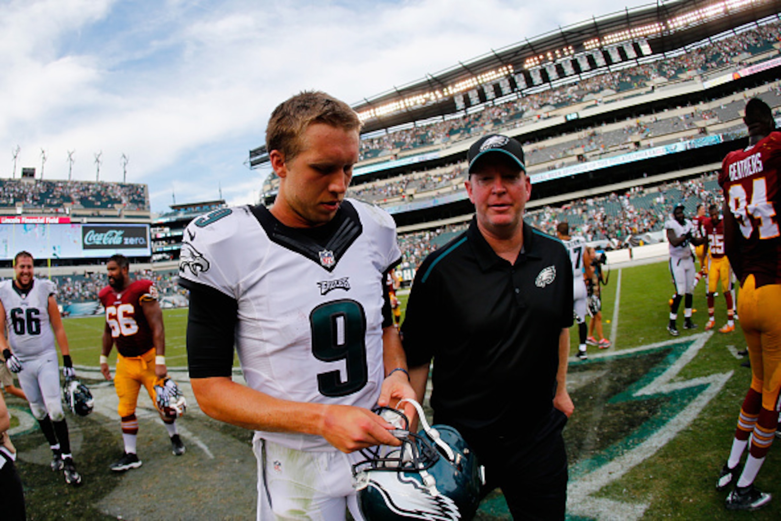 PHILADELPHIA, PA - SEPTEMBER 21:  Quarterback Nick Foles #9 of the Philadelphia Eagles and head coach Chip Kelly of the Philadelphia Eagles walk off the field after their 37-34 win over the Washington Redskins at Lincoln Financial Field on September 21, 2
