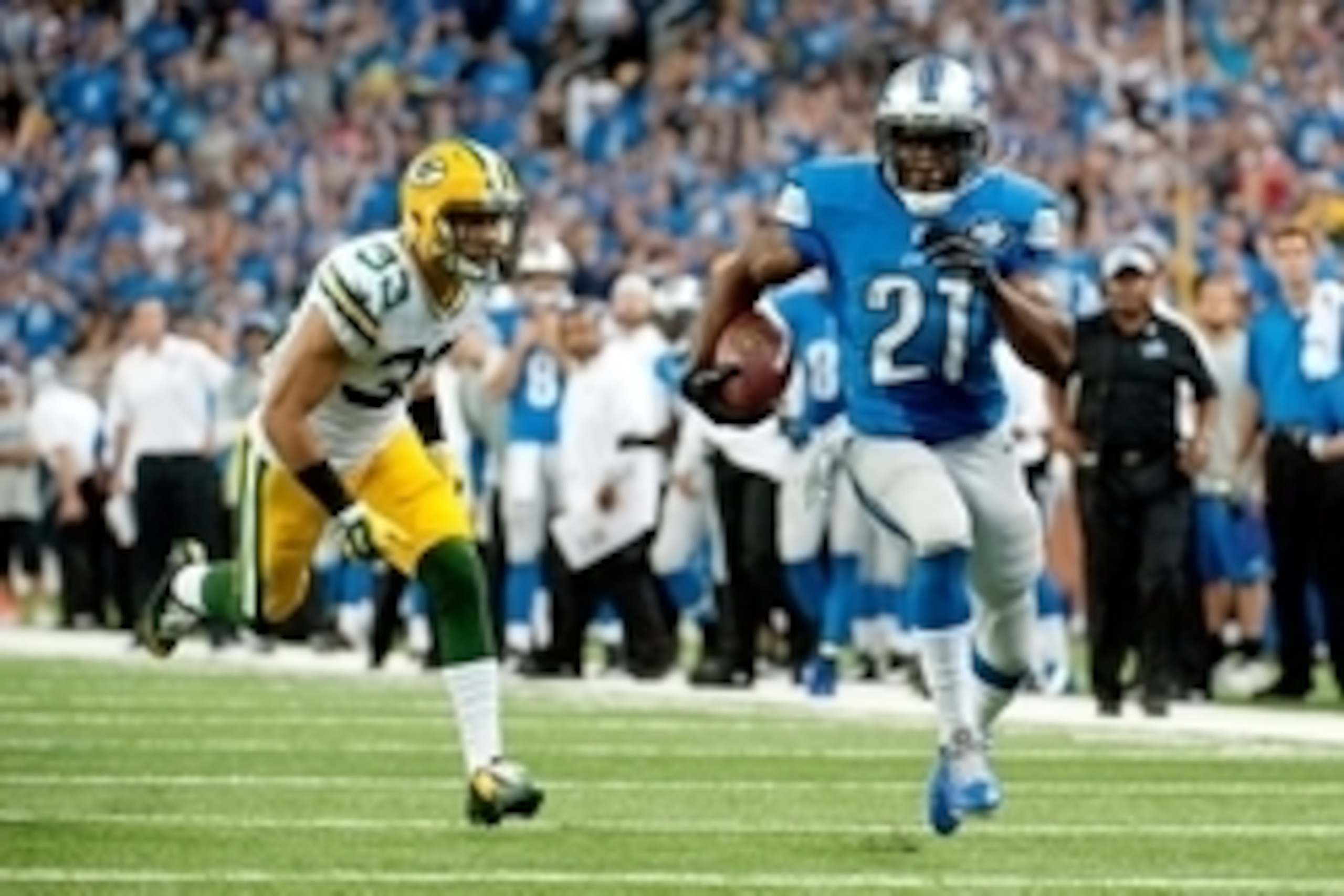 Sep 21, 2014; Detroit, MI, USA; Green Bay Packers free safety Micah Hyde (33) is unable to catch Detroit Lions running back Reggie Bush (21) as he runs for a touchdown during the fourth quarter at Ford Field. Mandatory Credit: Tim Fuller-USA TODAY Sports