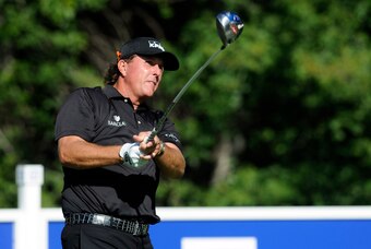 Aug 29, 2014; Norton, MA, USA; Phil Mickelson watches his tee shot on the 14th hole during the first round of the Deutsche Bank Championship golf tournament at TPC of Boston. Mandatory Credit: Mark Konezny-USA TODAY Sports