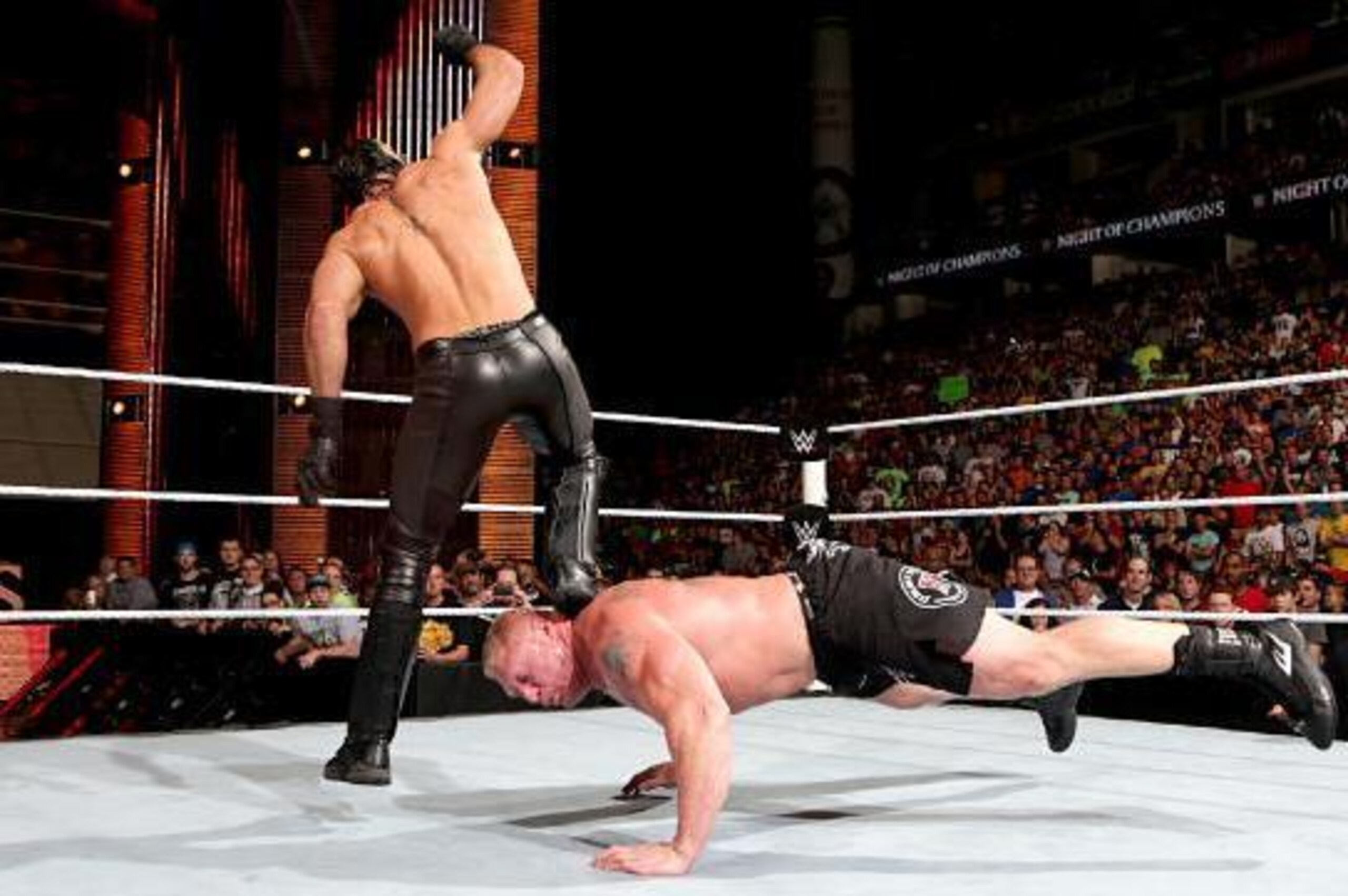Seth Rollins hits the Curb Stomp on Brock Lesnar.