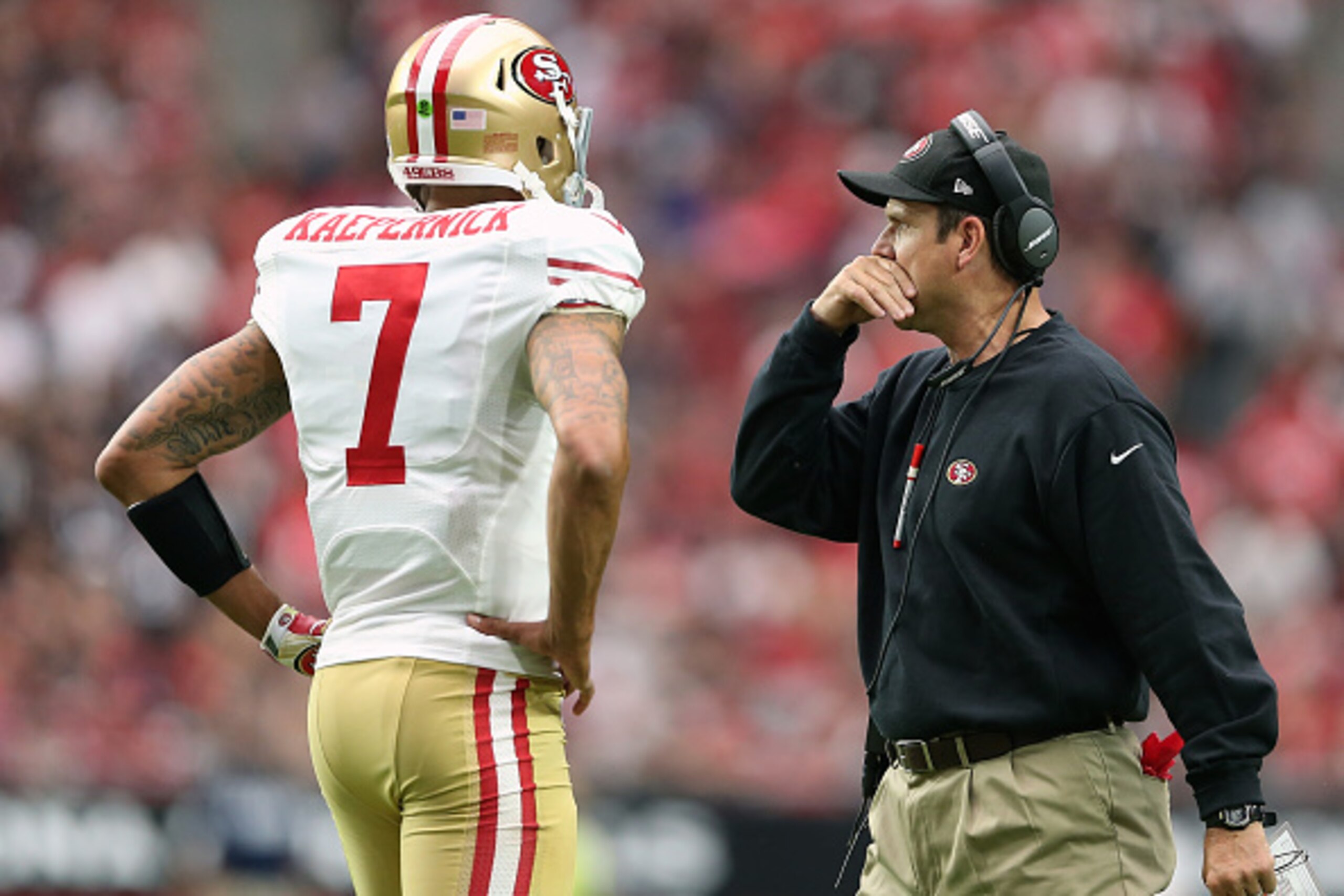 GLENDALE, AZ - SEPTEMBER 21: Head coach Jim Harbaugh of the San Francisco 49ers talks with quarterback Colin Kaepernick #7 during the first quarter of the NFL game against the Arizona Cardinals at the University of Phoenix Stadium on September 21, 2014 in