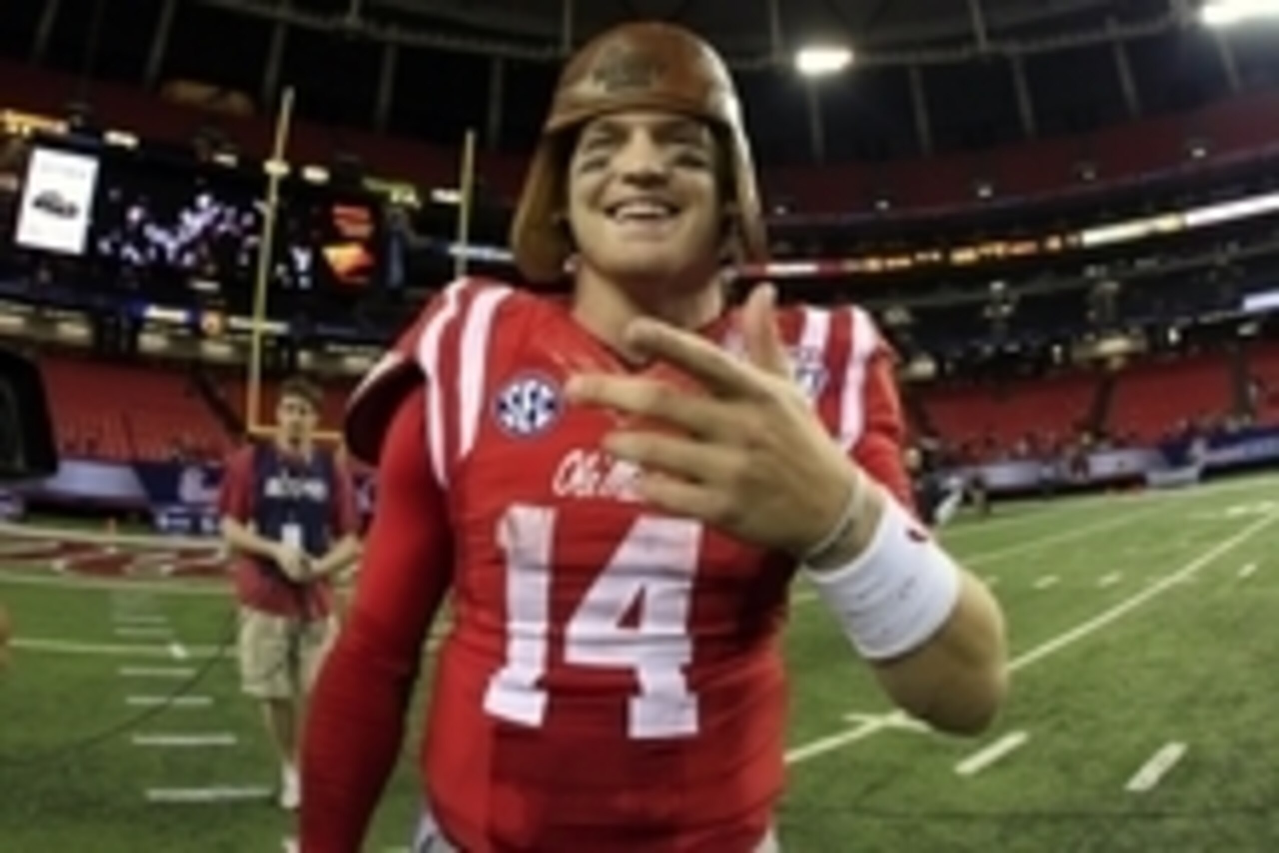 Aug 28, 2014; Atlanta, GA, USA; Mississippi Rebels quarterback Bo Wallace (14) wears the old leather helmet following their win over the Boise State Broncos in the 2014 Chick-fil-a Kickoff Game at the Georgia Dome. The Rebels defeated the Broncos 35-13. M