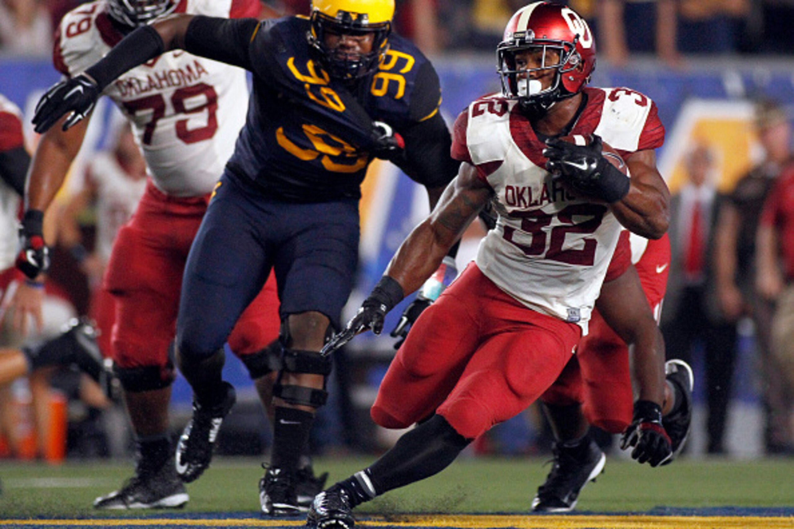 MORGANTOWN, WV - SEPTEMBER 20: Samaje Perine #32 of the Oklahoma Sooners rushes in the second half against Dontrill Hyman #99 of the West Virginia Mountaineers during the game on September 20, 2014 at Mountaineer Field in Morgantown, West Virginia. (Pho MORGANTOWN, WV - SEPTEMBER 20: Samaje Perine #32 of the Oklahoma Sooners rushes in the second half against Dontrill Hyman #99 of the West Virginia Mountaineers during the game on September 20, 2014 at Mountaineer Field in Morgantown, West Virginia. (Pho