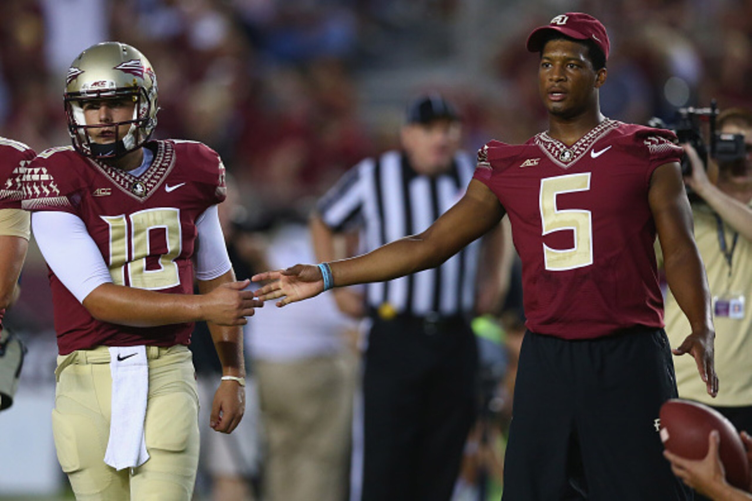 TALLAHASSEE, FL - SEPTEMBER 20: Jameis Winston #5 of the Florida State Seminoles shakes hands with Sean Maguire #10 on the field during pregame against the Clemson Tigers at Doak Campbell Stadium on September 20, 2014 in Tallahassee, Florida. (Photo by TALLAHASSEE, FL - SEPTEMBER 20: Jameis Winston #5 of the Florida State Seminoles shakes hands with Sean Maguire #10 on the field during pregame against the Clemson Tigers at Doak Campbell Stadium on September 20, 2014 in Tallahassee, Florida. (Photo by