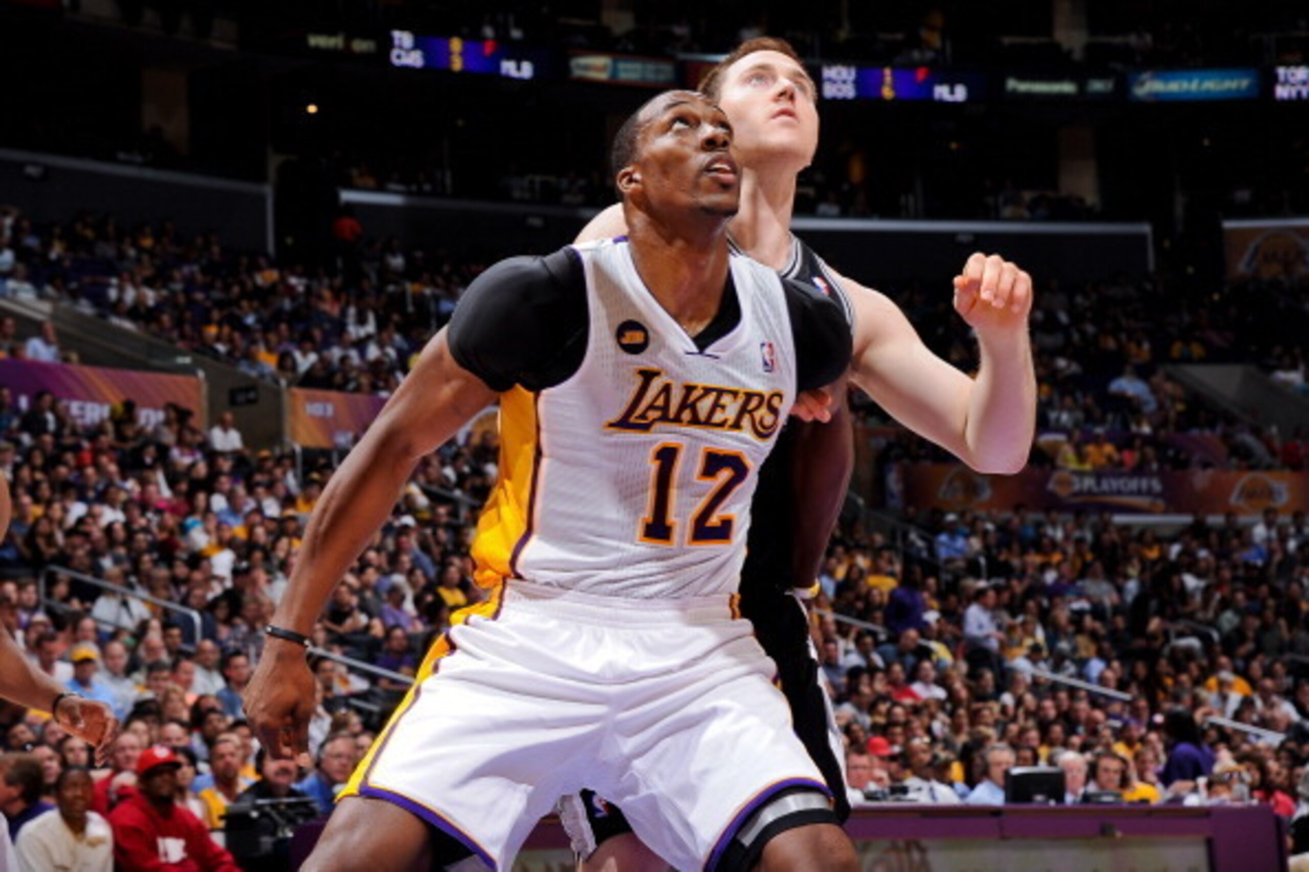 LOS ANGELES, CA - APRIL 28: Dwight Howard #12 of the Los Angeles Lakers battles for rebound position against Aron Baynes #16 of the San Antonio Spurs in Game Four of the Western Conference Quarterfinals during the 2013 NBA Playoffs at Staples Center on Ap