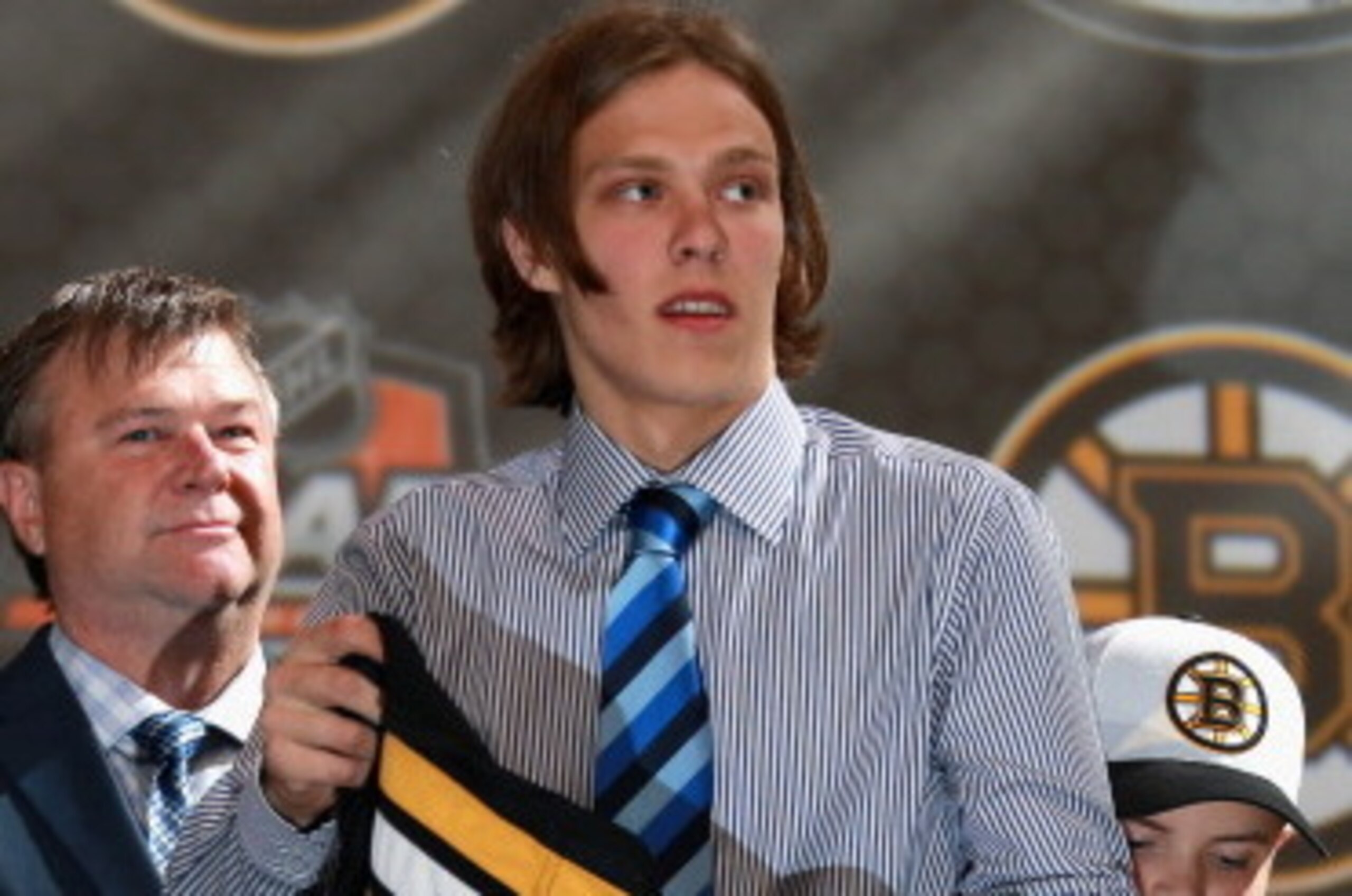 PHILADELPHIA, PA - JUNE 27:  David Pastrnak puts on his jersey after being selected 25th overall by the Boston Bruins during the 2014 NHL Entry Draft at Wells Fargo Center on June 27, 2014 in Philadelphia, Pennsylvania.  (Photo by Dave Sandford/NHLI via G