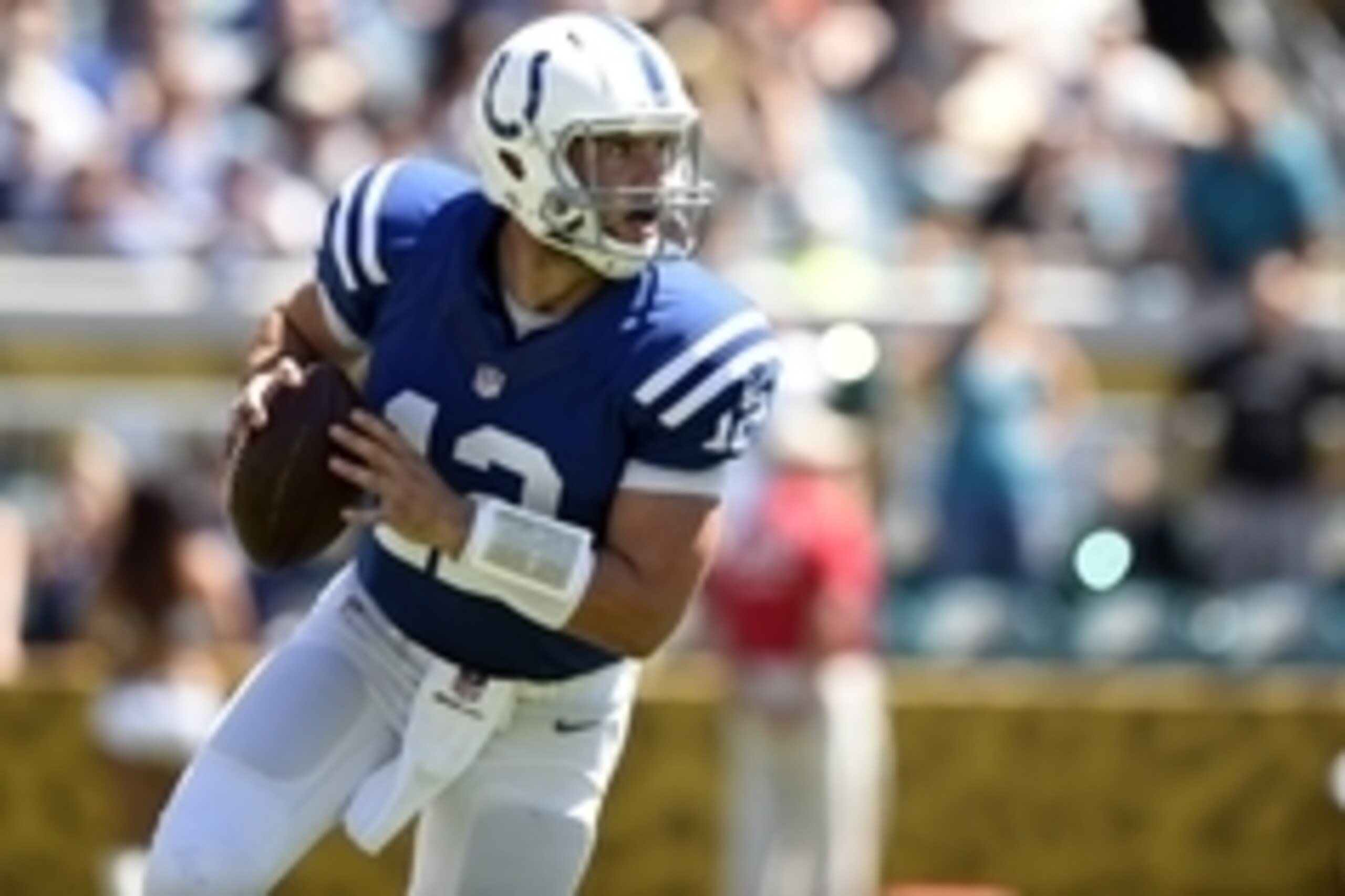 Sep 21, 2014; Jacksonville, FL, USA; Indianapolis Colts quarterback Andrew Luck (12) rolls out to pass against the Jacksonville Jaguars during the first quarter at EverBank Field. Mandatory Credit: John David Mercer-USA TODAY Sports