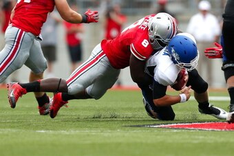 COLUMBUS, OH - AUGUST 31: Noah Spence #8 of the Ohio State Buckeyes sacks Joe Licata #16 of the Buffalo Bulls during the third quarter on August  31, 2013 at Ohio Stadium in Columbus, Ohio. Ohio State defeated Buffalo 40-20. (Photo by Kirk Irwin/Getty Ima