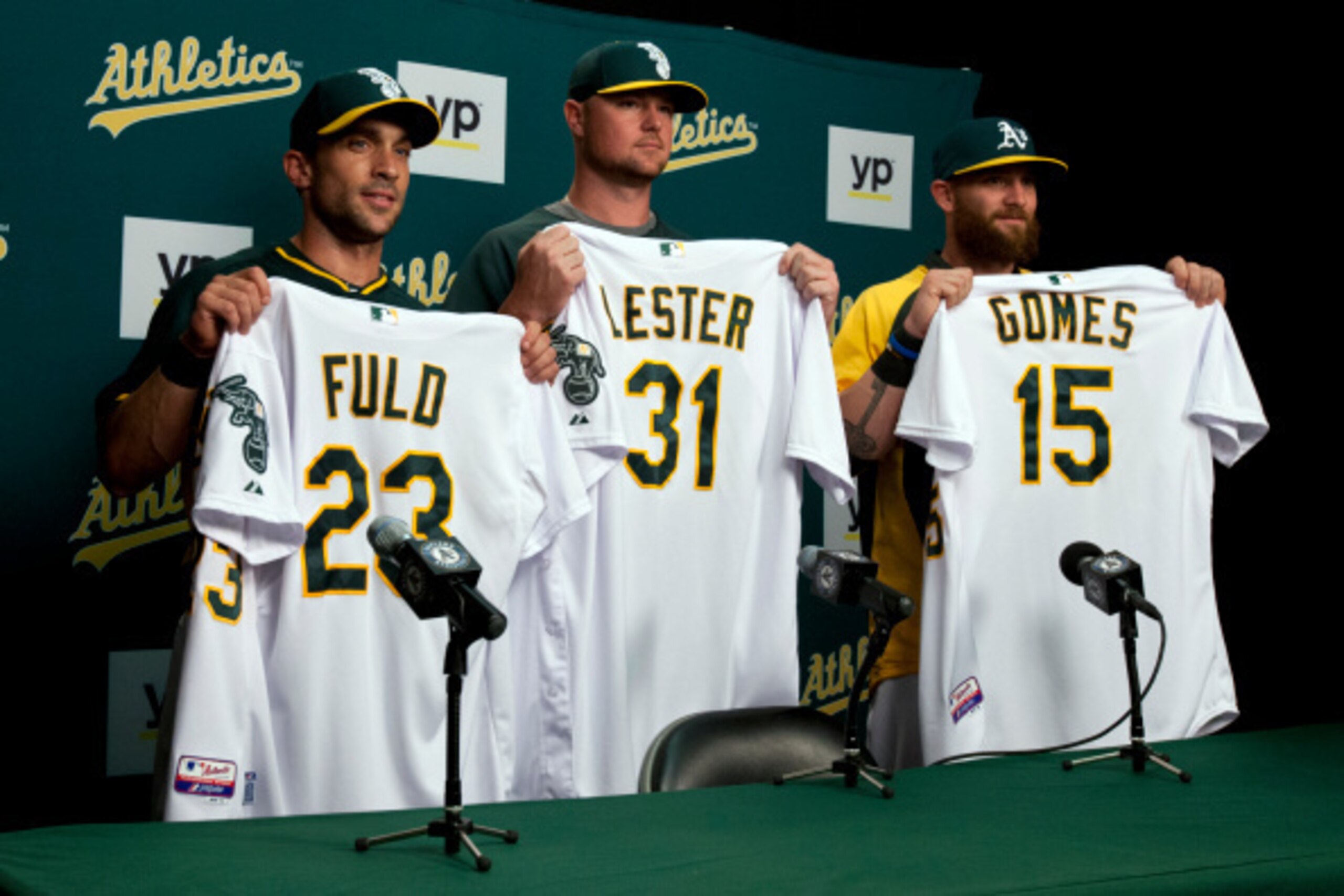 OAKLAND, CA - AUGUST 01:  Sam Fuld #23 of the Oakland Athletics, Jon Lester #31 and Jonny Gomes #15 hold up jerseys during a press conference before the game against the Kansas City Royals at O.co Coliseum on August 1, 2014 in Oakland, California. (Photo 