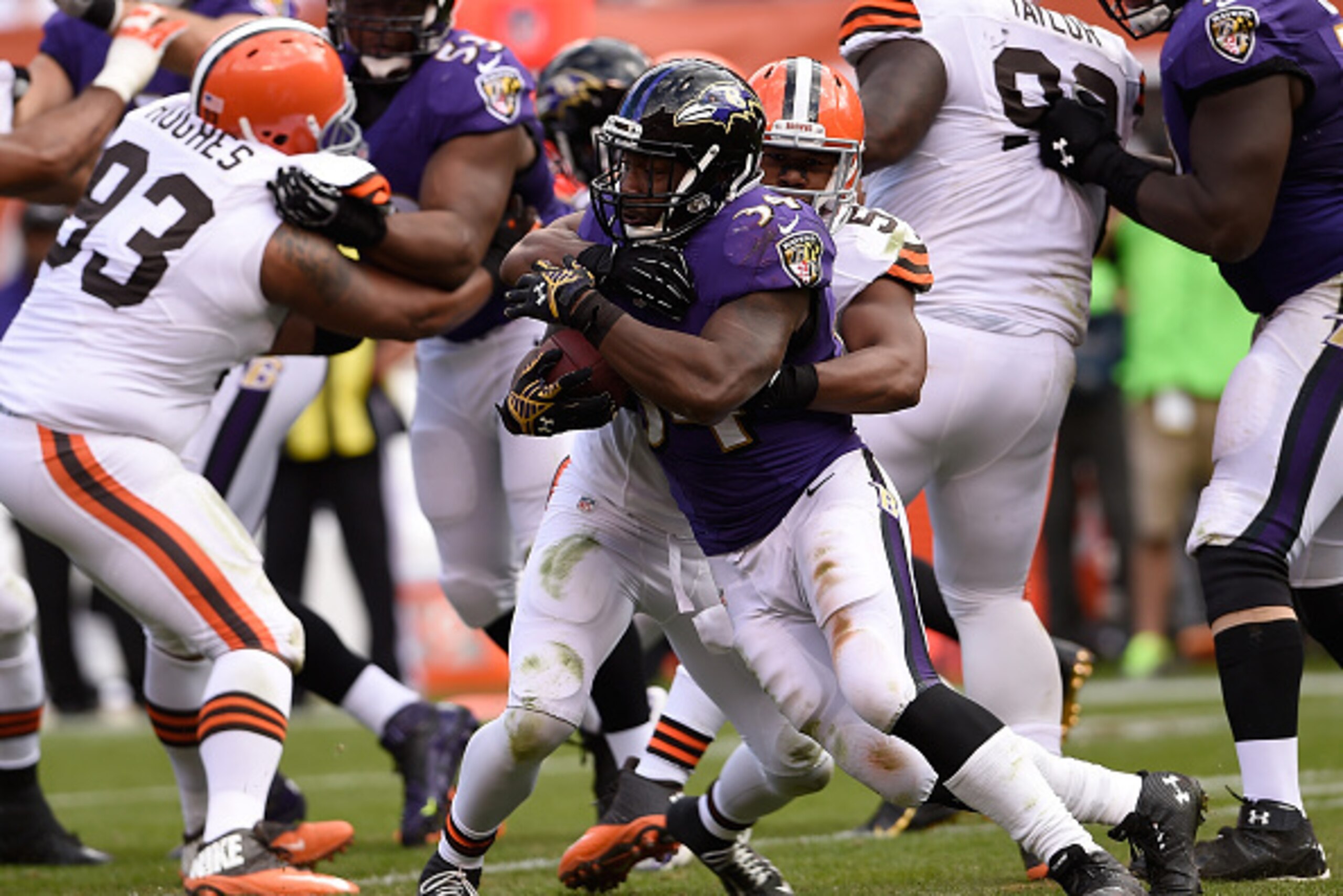 CLEVELAND, OH - SEPTEMBER 21:  Lorenzo Taliaferro #34 of the Baltimore Ravens gets wrapped up by Craig Robertson #53 of the Cleveland Browns during the fourth quarter at FirstEnergy Stadium on September 21, 2014 in Cleveland, Ohio.  (Photo by Jason Miller