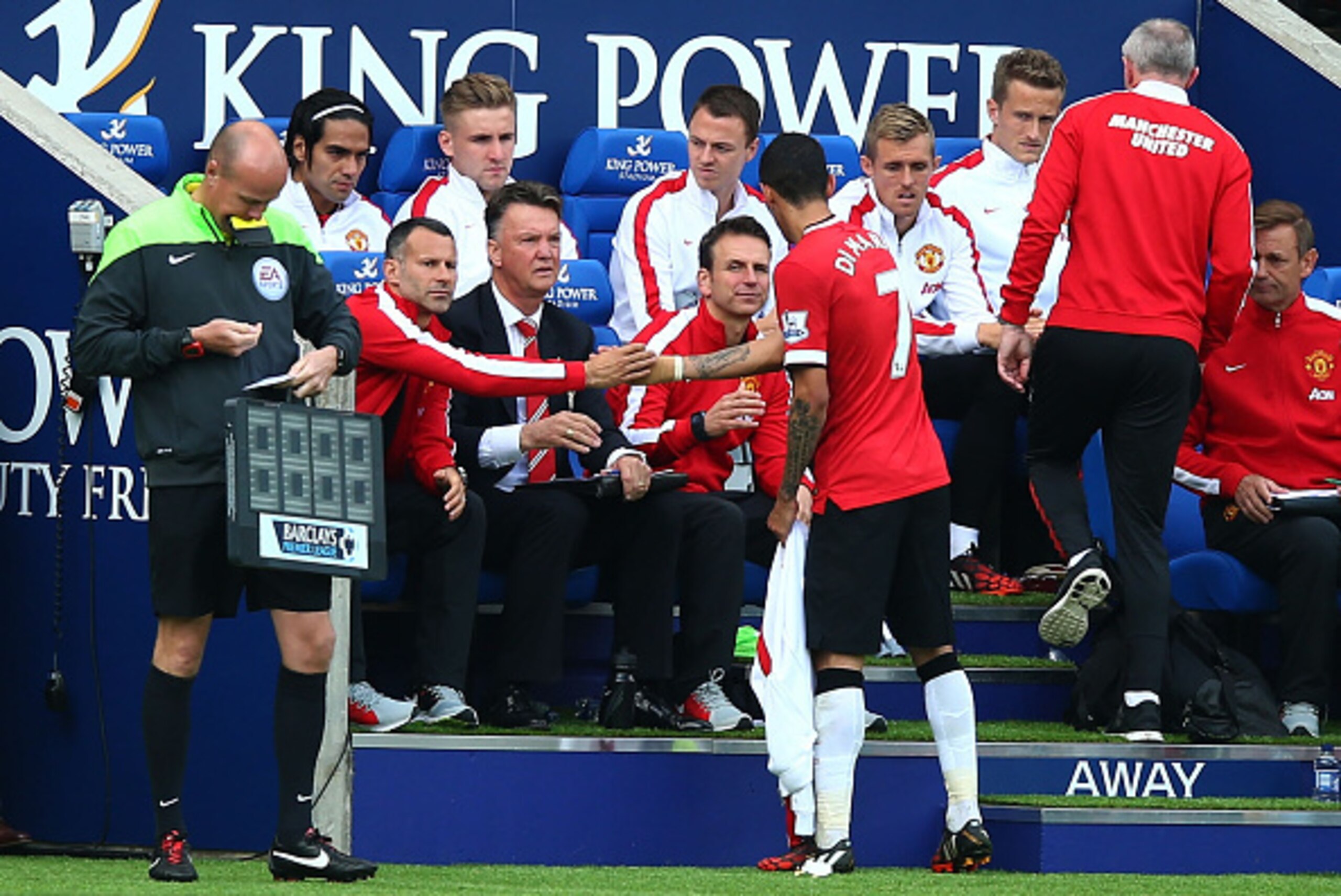 LEICESTER, ENGLAND - SEPTEMBER 21:  Angel di Maria of Manchester United shakes hands with Ryan Giggs the assisitant manager of Manchester United and Louis van Gaal the manager of Manchester United as he is substituted in the second half during the Barclay